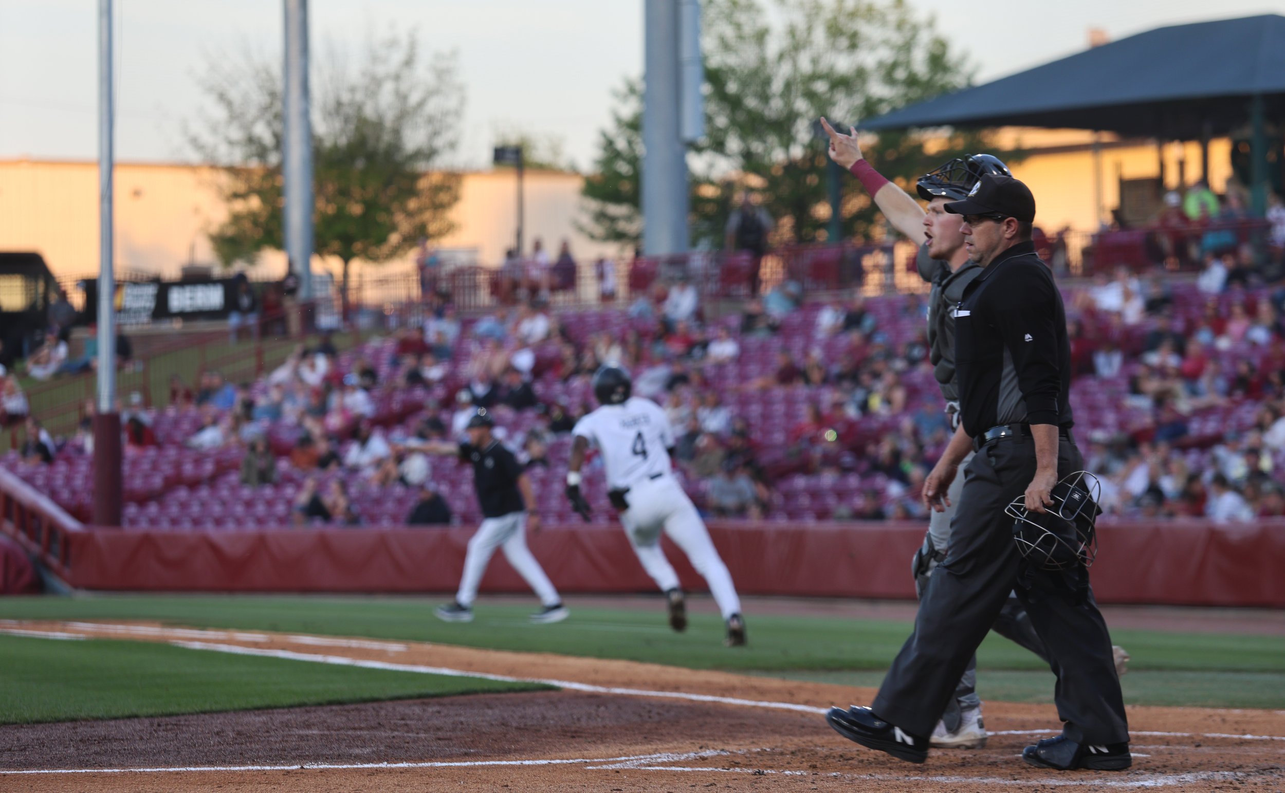 College of Charleston catcher reacts at home plate as South Carolina outfielder Erik Parker races toward the plate during the Gamecocks offensive rally.
