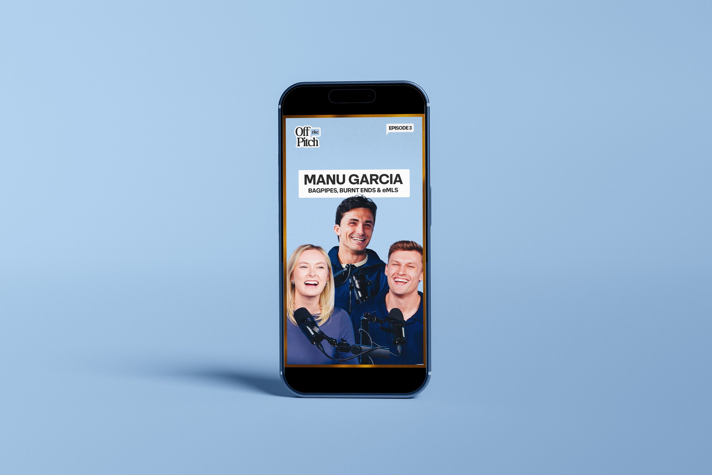 Smartphone displaying a podcast episode with three smiling hosts and text that reads 'Off the Pitch, Episode 3, Manu Garcia, Bagpipes, Burnt Ends & eMLS'.