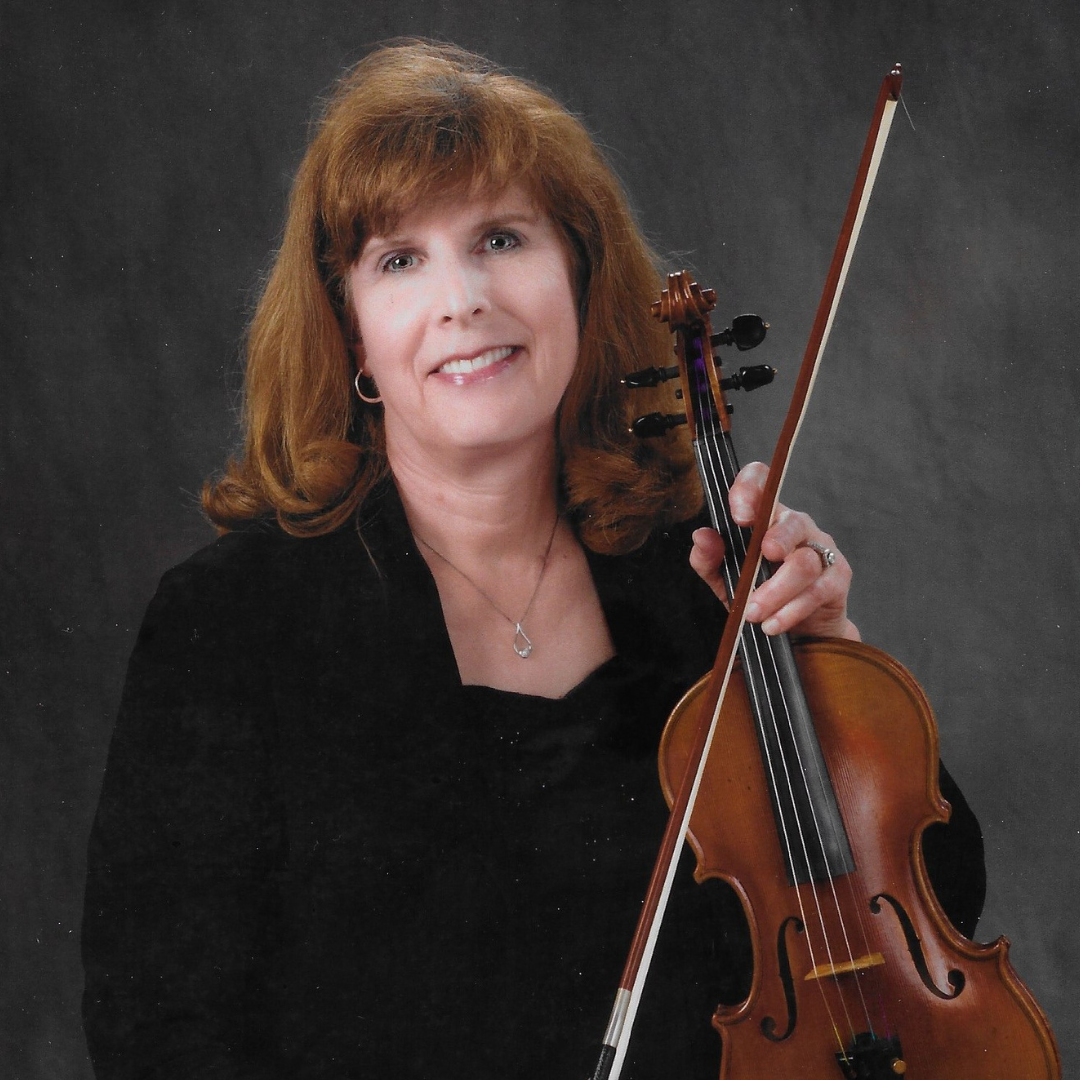 A woman with red hair holding a violin and bow against a dark background.