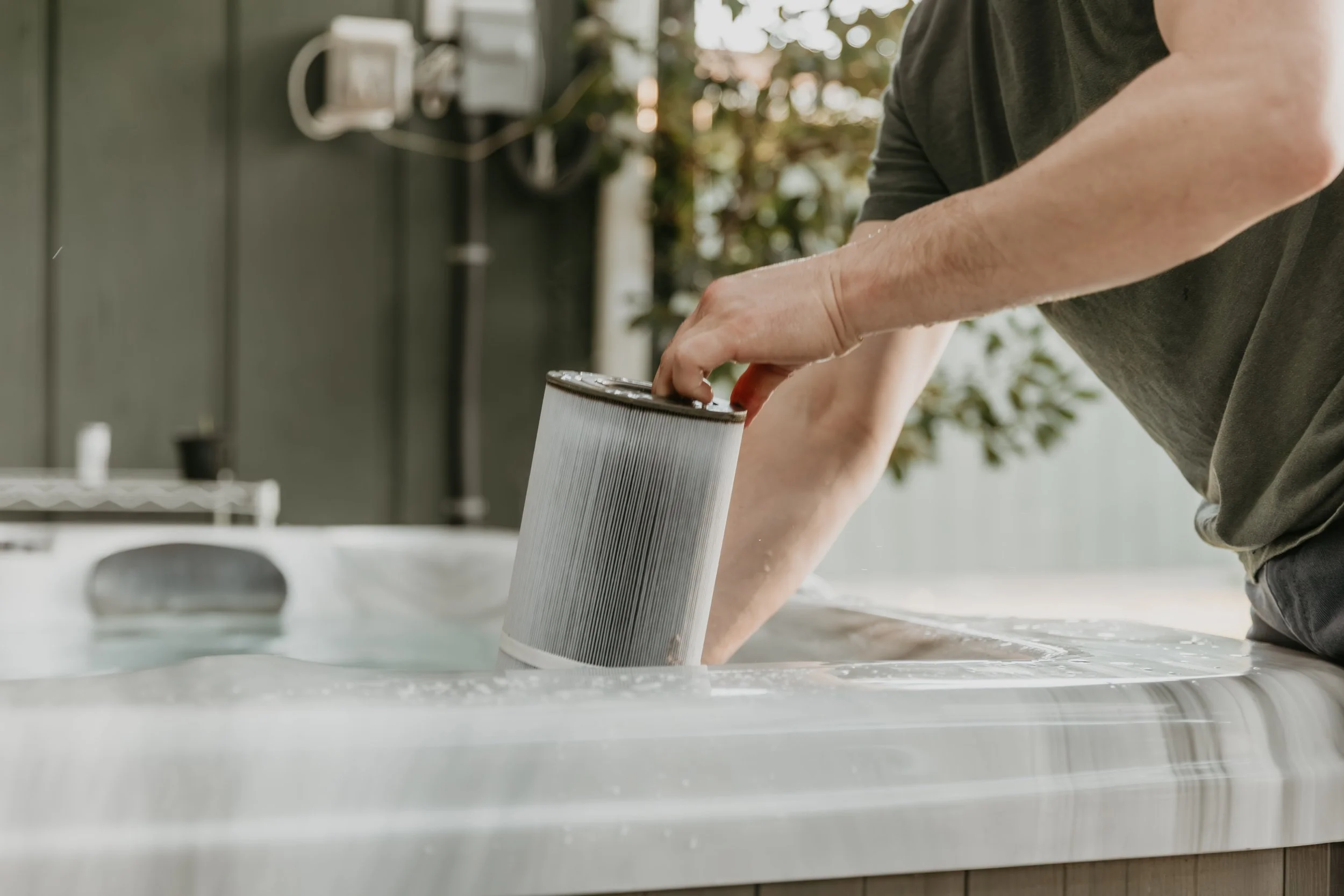 Person cleaning a filter in a Hot Tub Spa with water