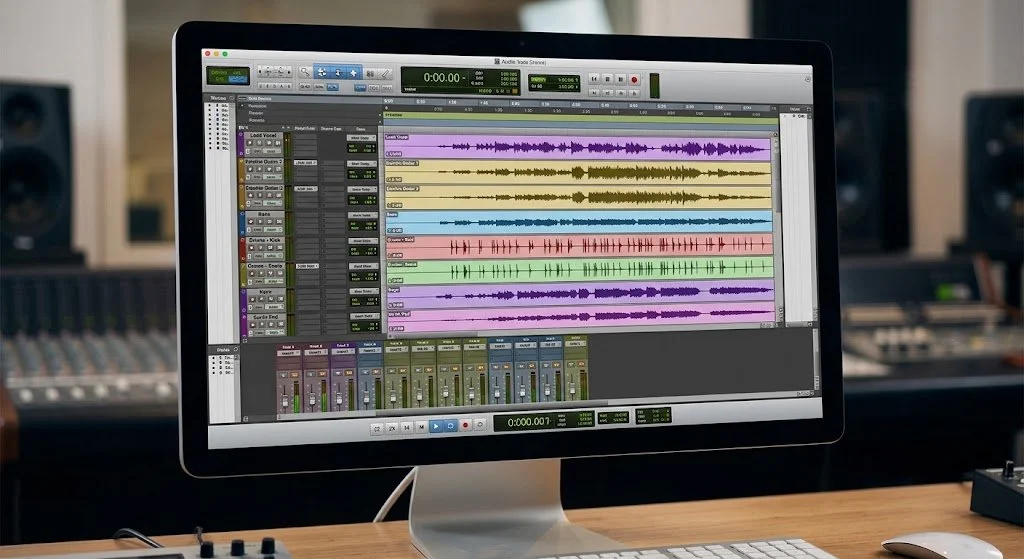 Computer screen displaying music production software with multiple audio tracks and waveforms.