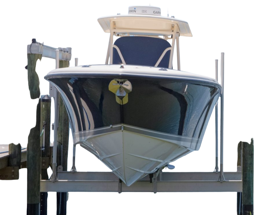 A large motorboat docked on a pier, viewed from the front, with a dark hull and a small section of white on the upper part.