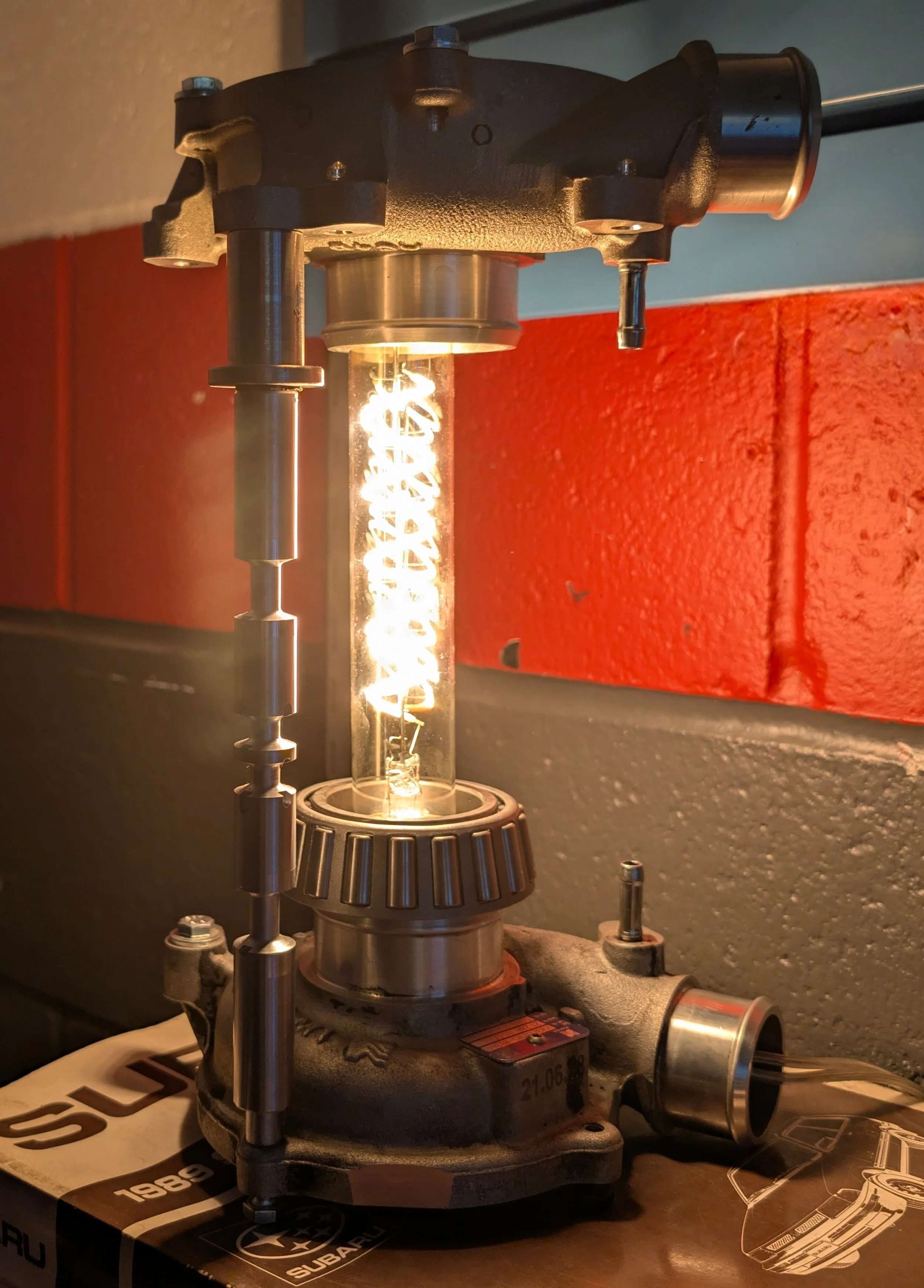 Turbo Lamp - two turbo housings stood apart with spools, a neat vintage bulb in between