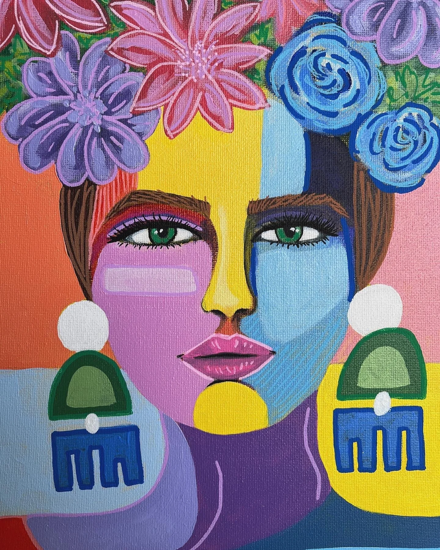 A colorful, stylized portrait of a woman with split face featuring one side in pink and purple tones and the other in blue tones. She has green eyes, purple lipstick, and wears large, geometric earrings and floral headpieces with pink and purple flow