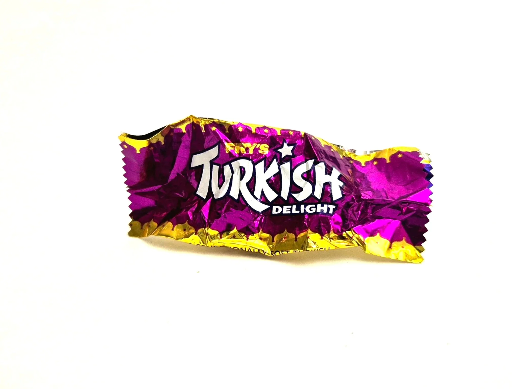 A crumpled piece of purple and yellow foil packaging for Ty Inc's Turkish Delight plush toy.