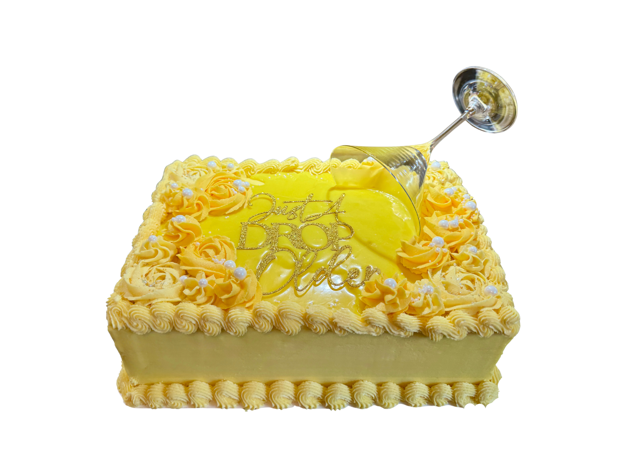 A rectangular lemon yellow birthday cake with a martini glass on top spilling yellow colored white chocolate ganache on to the top of the cake.  There is a gold topper that says 'Just a Drop Older.'