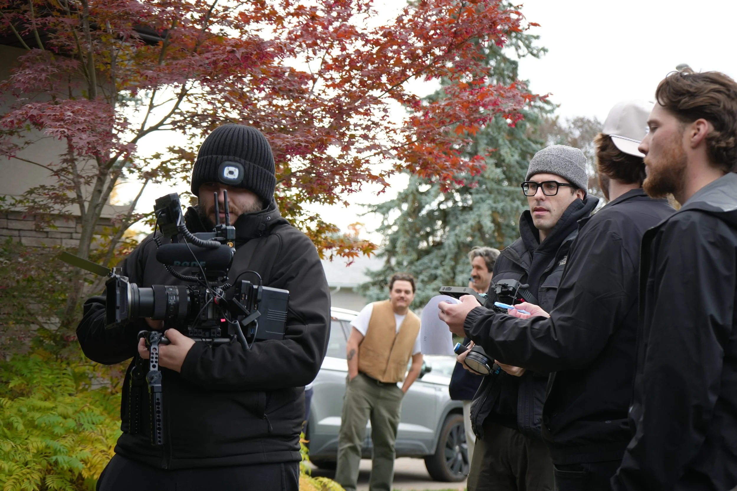 Film crew operating cinema camera during an outdoor commercial video production shoot