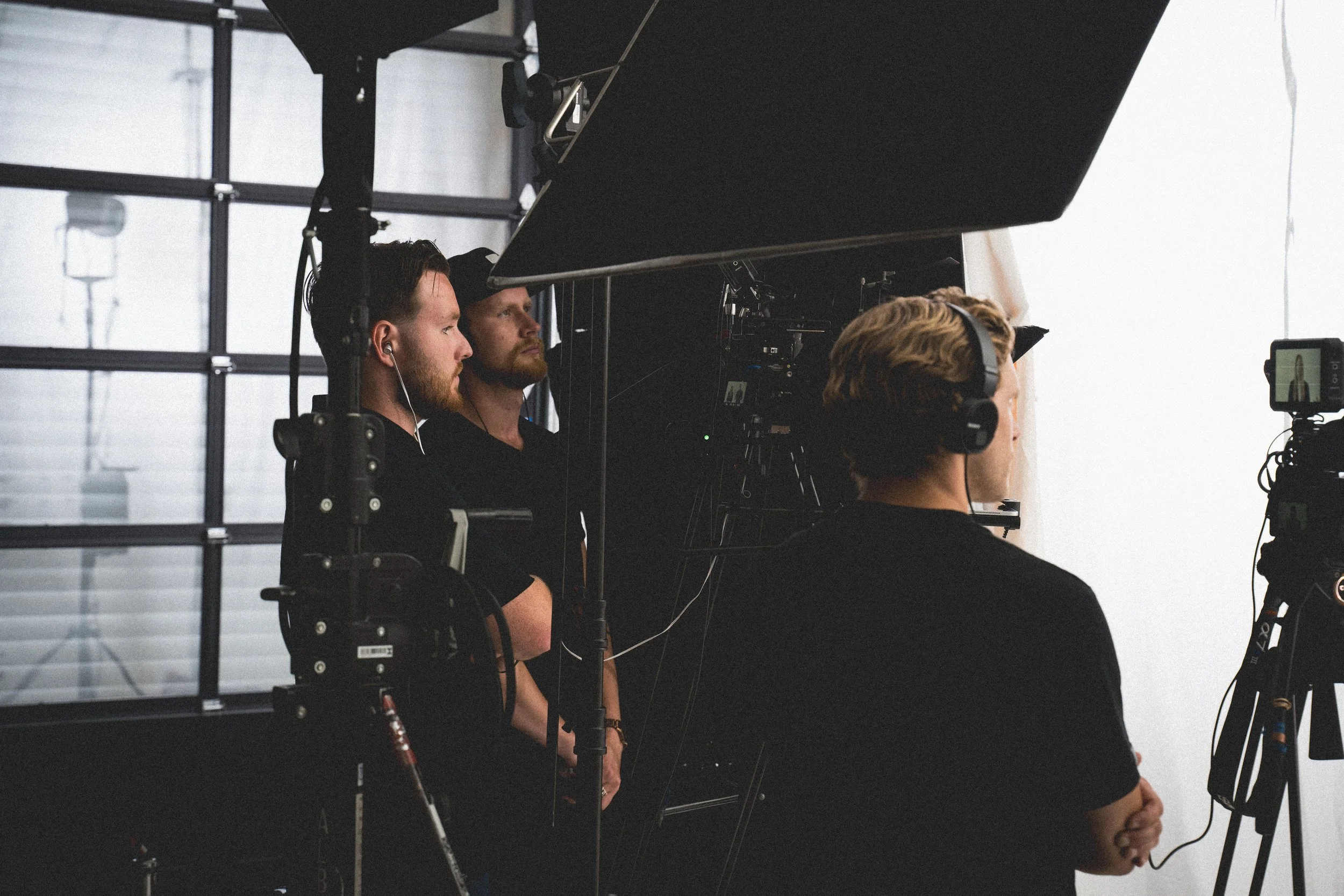 Video production crew reviewing footage on set during a commercial content shoot