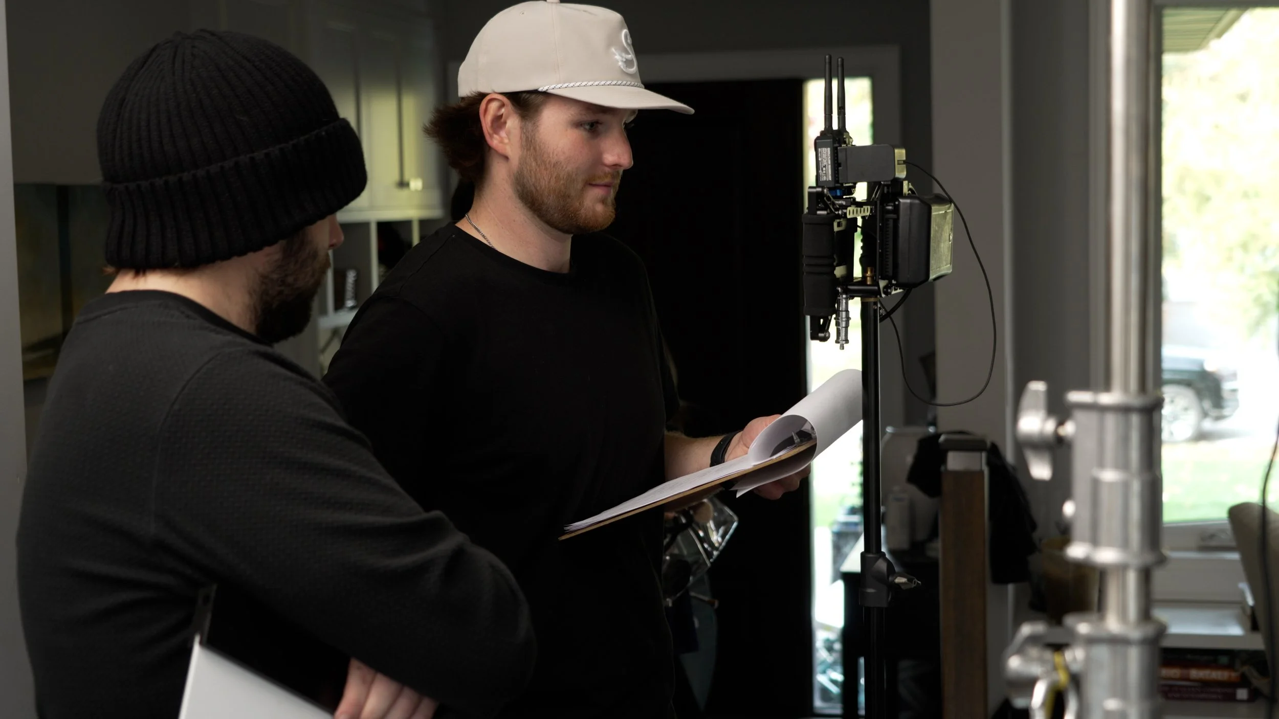 Videographer reviewing shot list and camera setup during a branded content production shoot