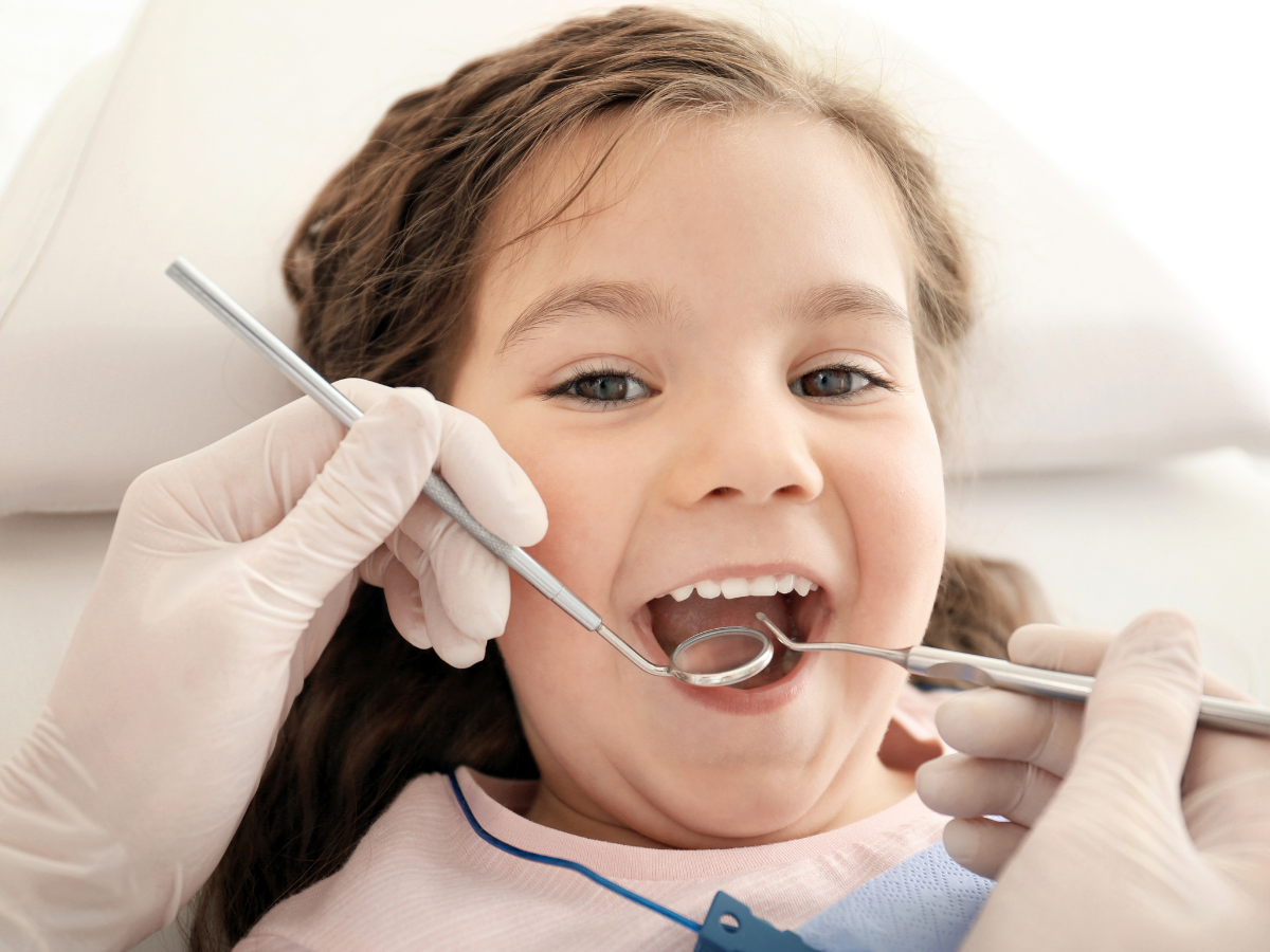 Young child receiving a gentle dental exam at Dental Care of Cerritos in Cerritos, California.