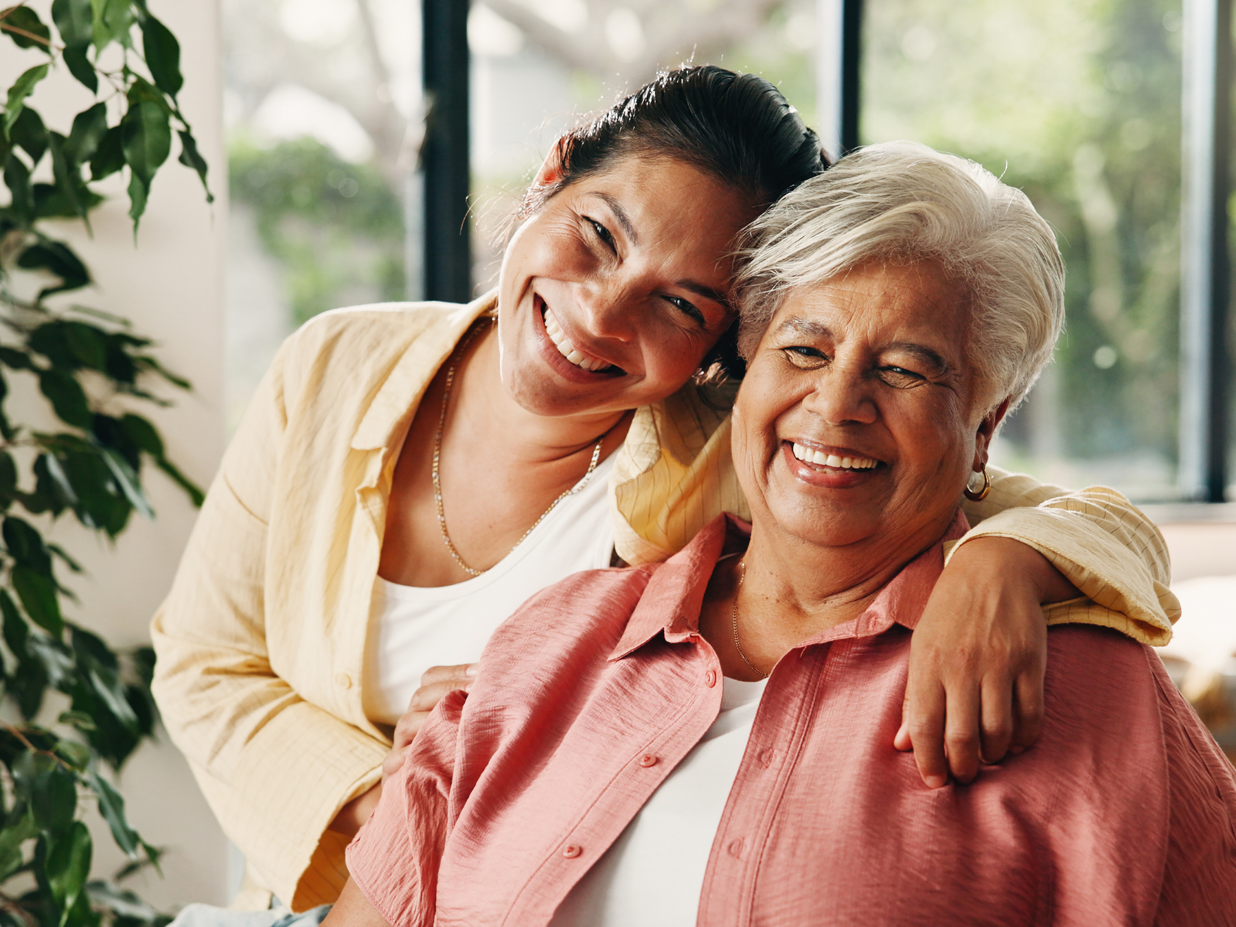 Adult daughter embracing her smiling mother, representing compassionate family dental care at Dental Care of Cerritos.