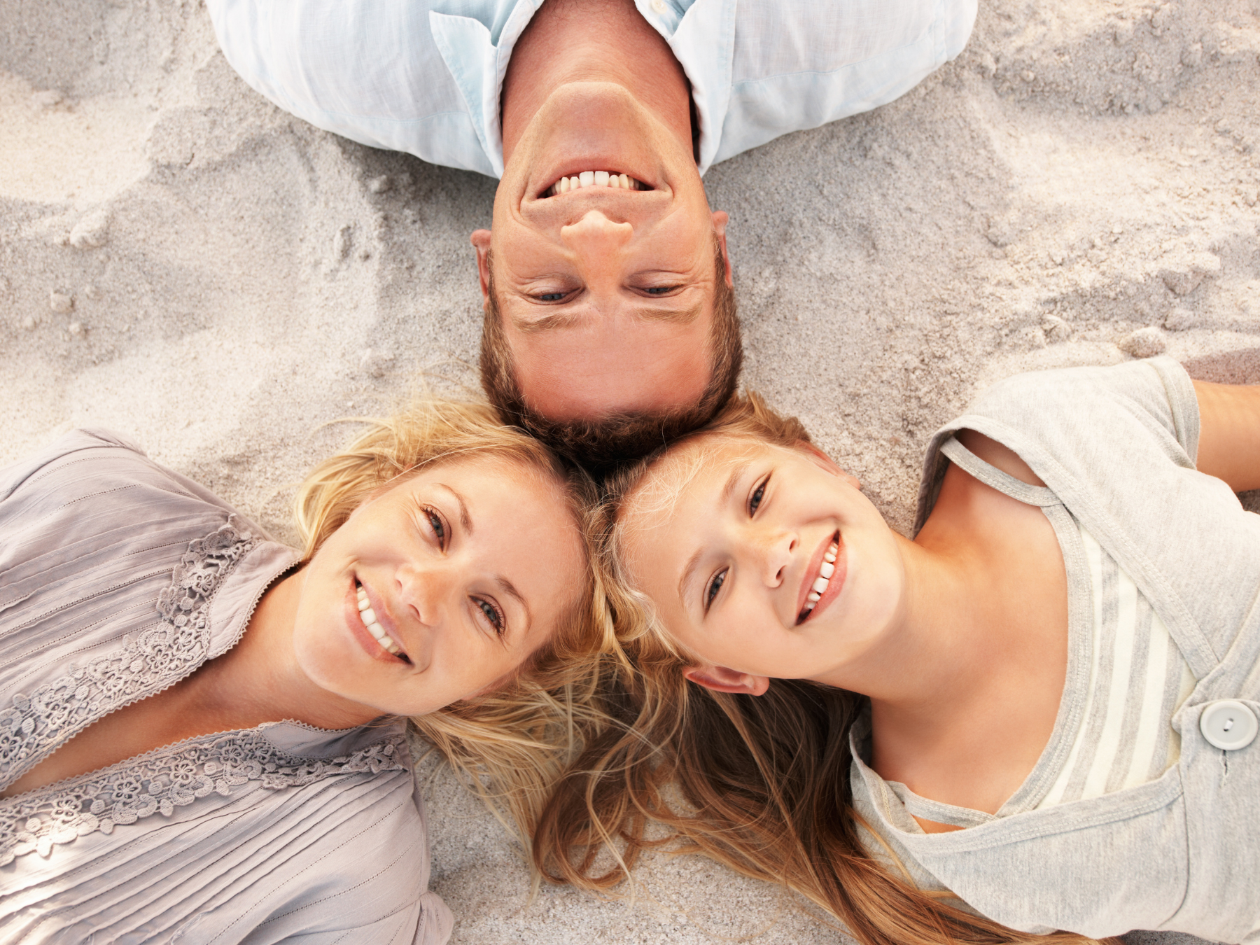 Smiling family representing specialty dentistry and comprehensive dental care for patients in Cerritos.