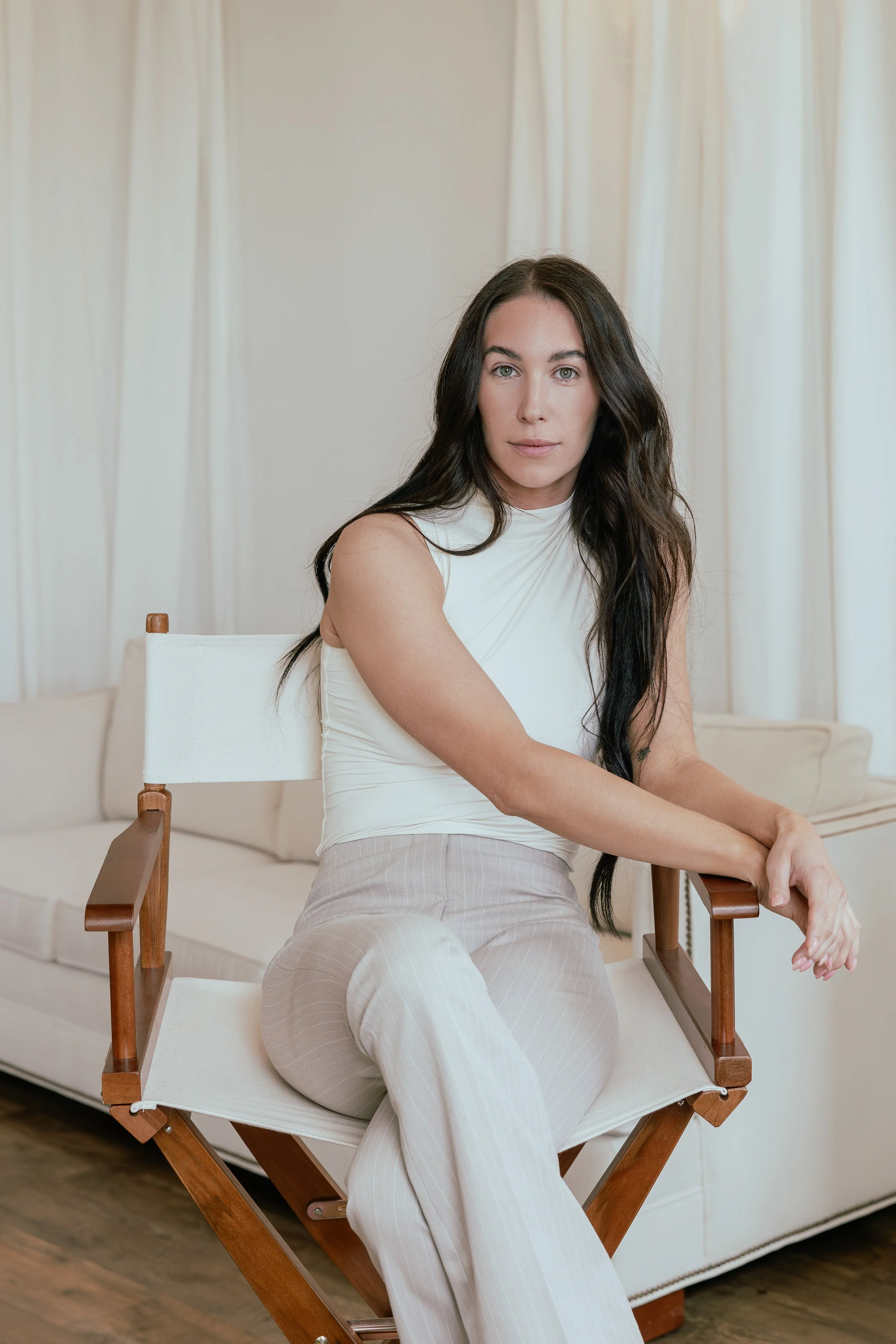 Gabriella Castellani, MS, OTR/L, Clinical Specialist at Medtronic and licensed Occupational Therapist, seated in a softly lit ivory studio.