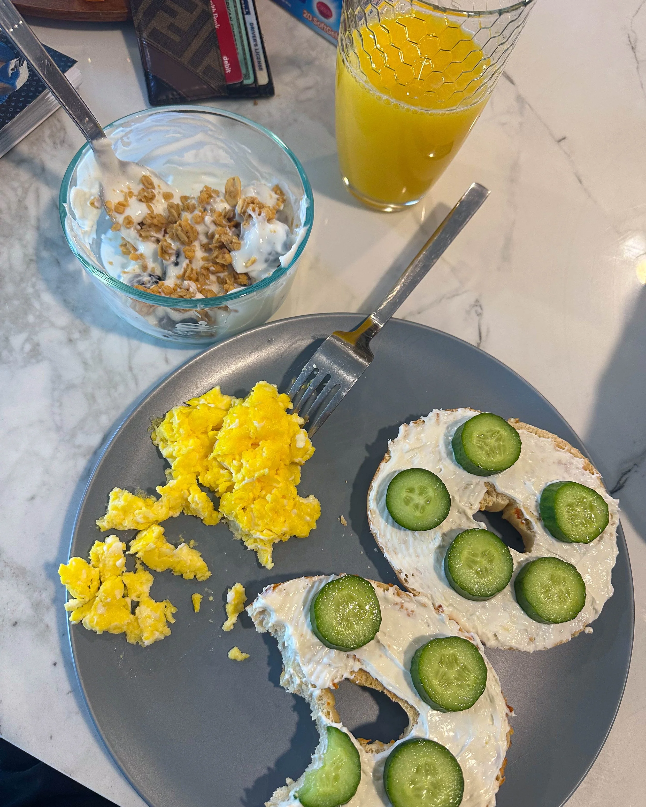 Simple recovery breakfast with eggs, yogurt, fruit, and a bagel as part of an endometriosis healing routine.