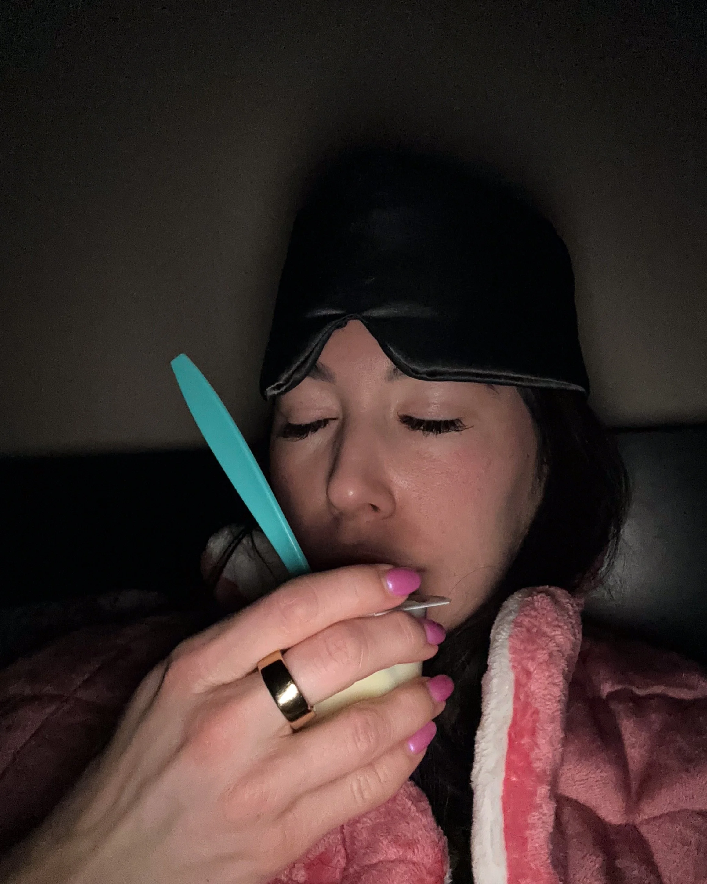 Woman resting at night during endometriosis recovery as part of a gentle nighttime routine.