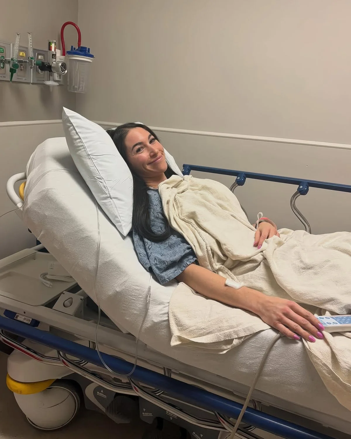 Gabriella Castellani smiling in hospital bed after endometriosis surgery