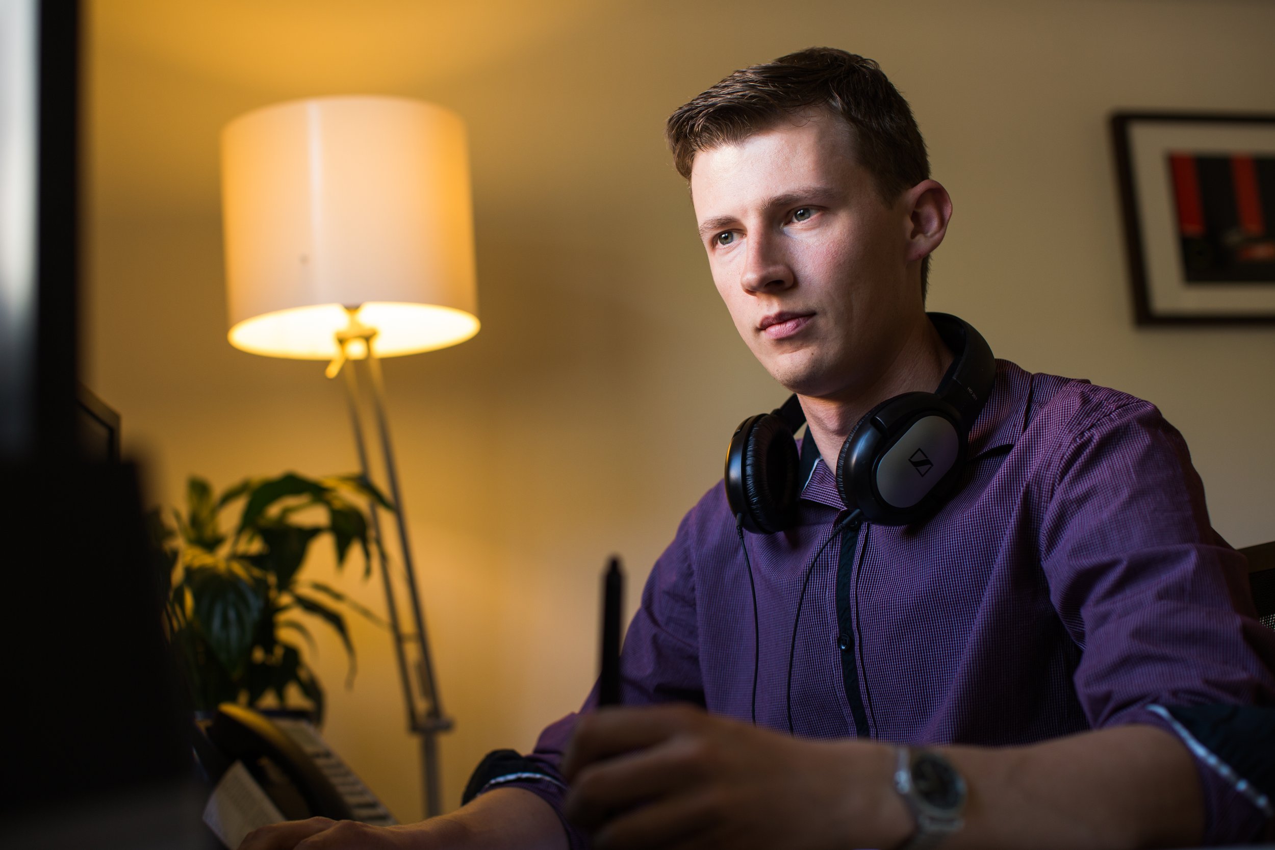 Professional video editor and animator Alistair Schmidt working at his desk in a post-production studio with a pen display stylus.