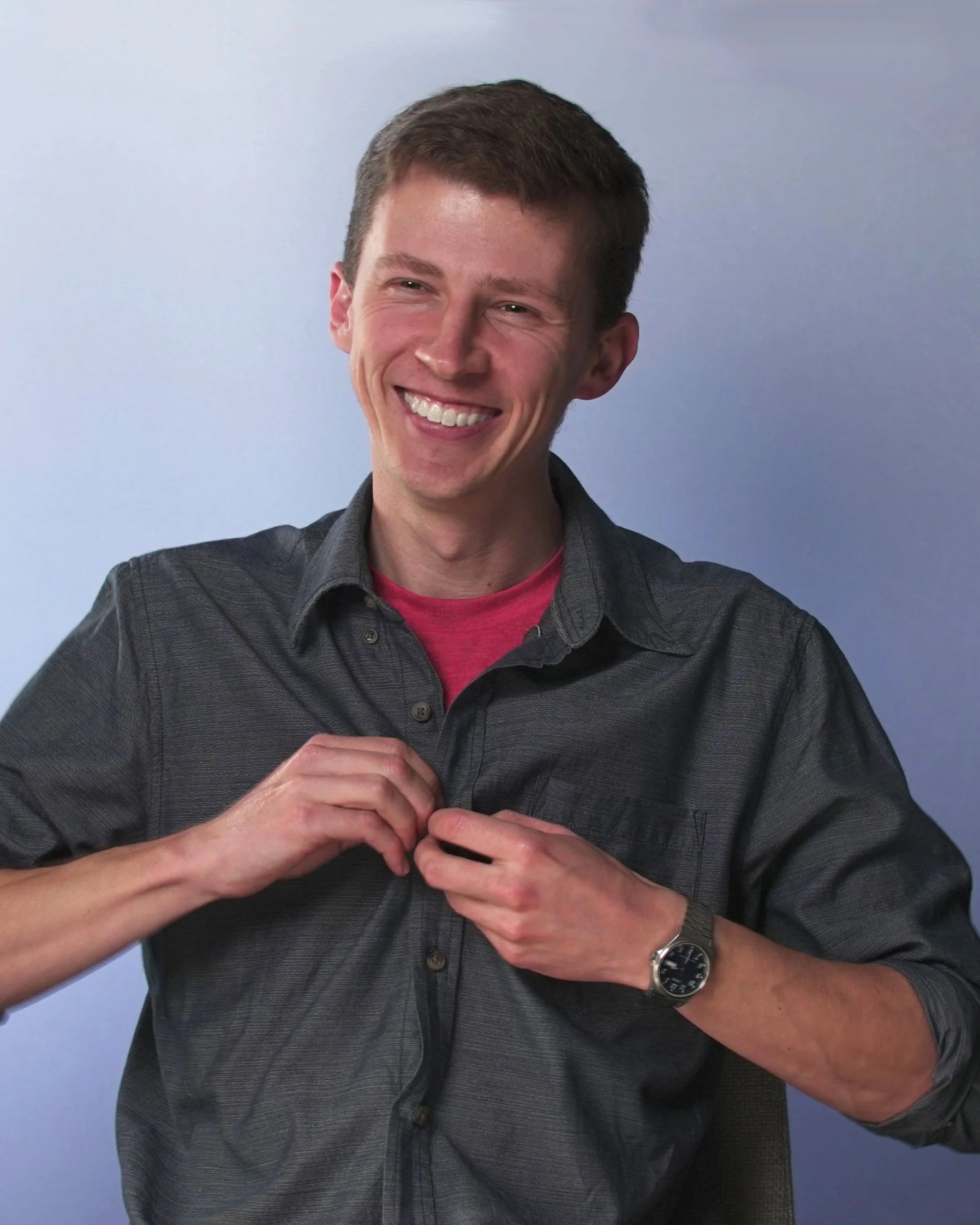 Filmmaker and video production specialist Alistair Schmidt smiling in a professional headshot for his About Me profile. Creative director and video editor based in Adelaide, showcasing corporate video production and media services.