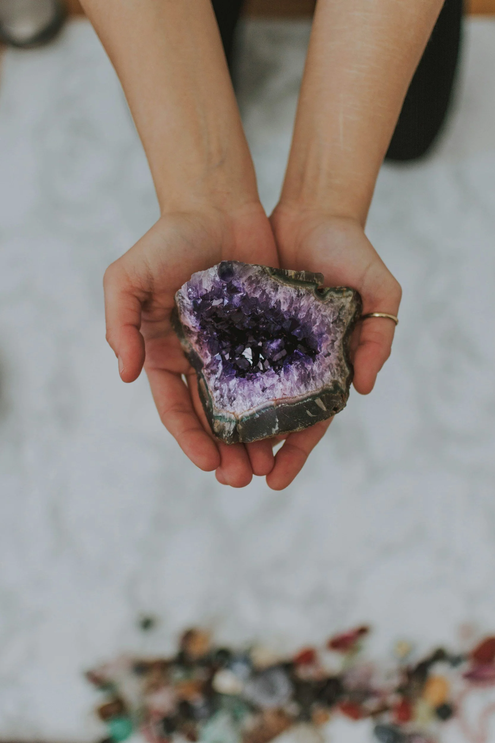 An amethyst held with two hands symbolizing healing