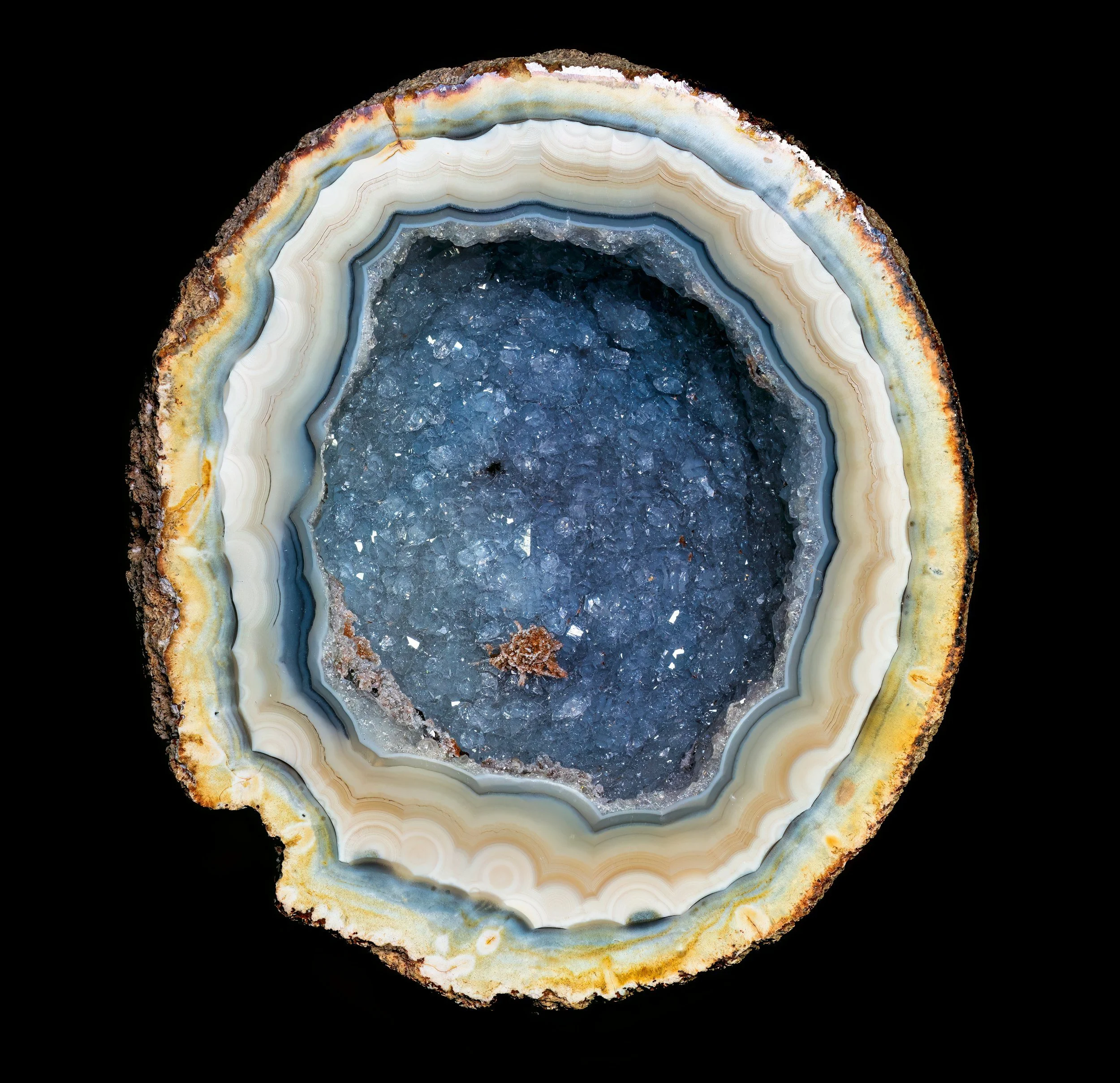 A cross section of a blue geode with white and beige edges