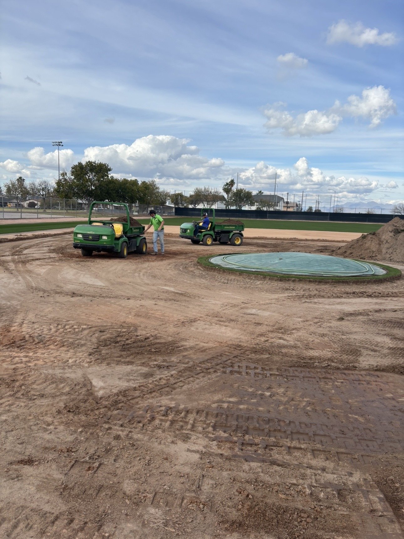 True Hop Field Co team members working on baseball field construction and resurfacing.