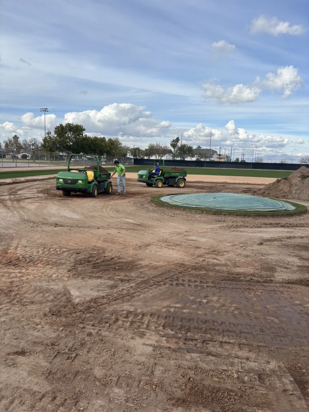 True Hop Field Co team members working on baseball field construction and resurfacing.