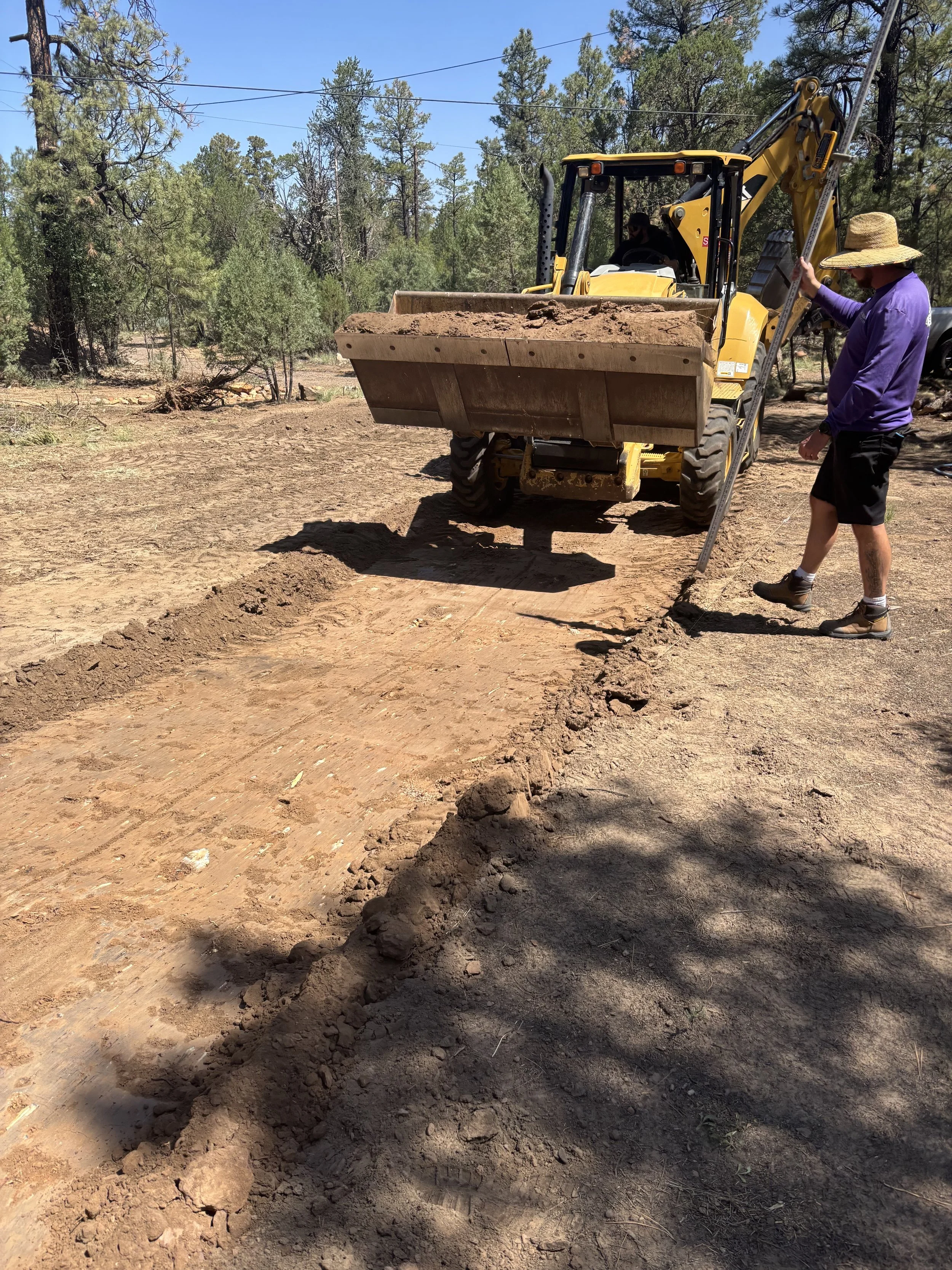 True Hop Field Co, Arizona sports field & court construction, team members laser grading a pickleball court.