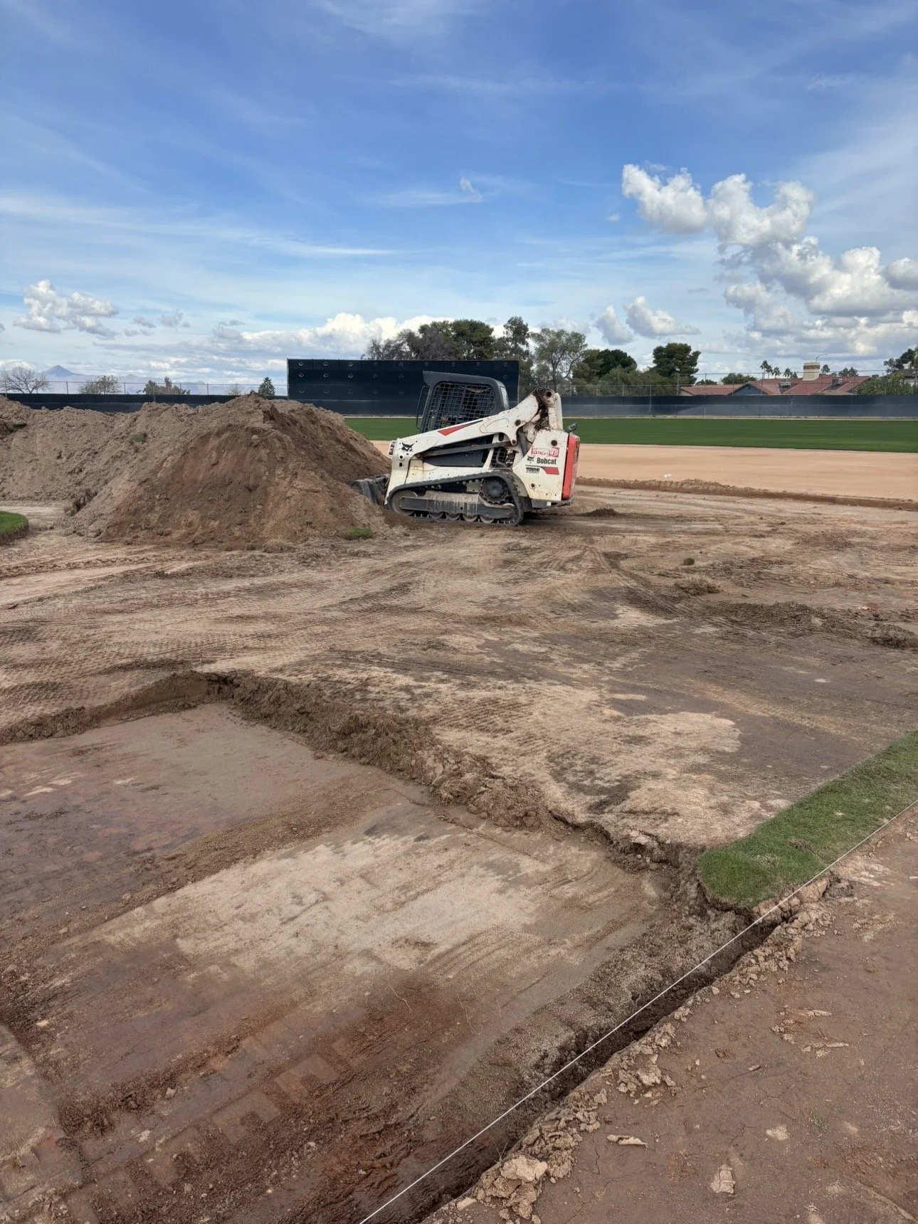 True Hop Field Co team members working on baseball field construction and resurfacing.