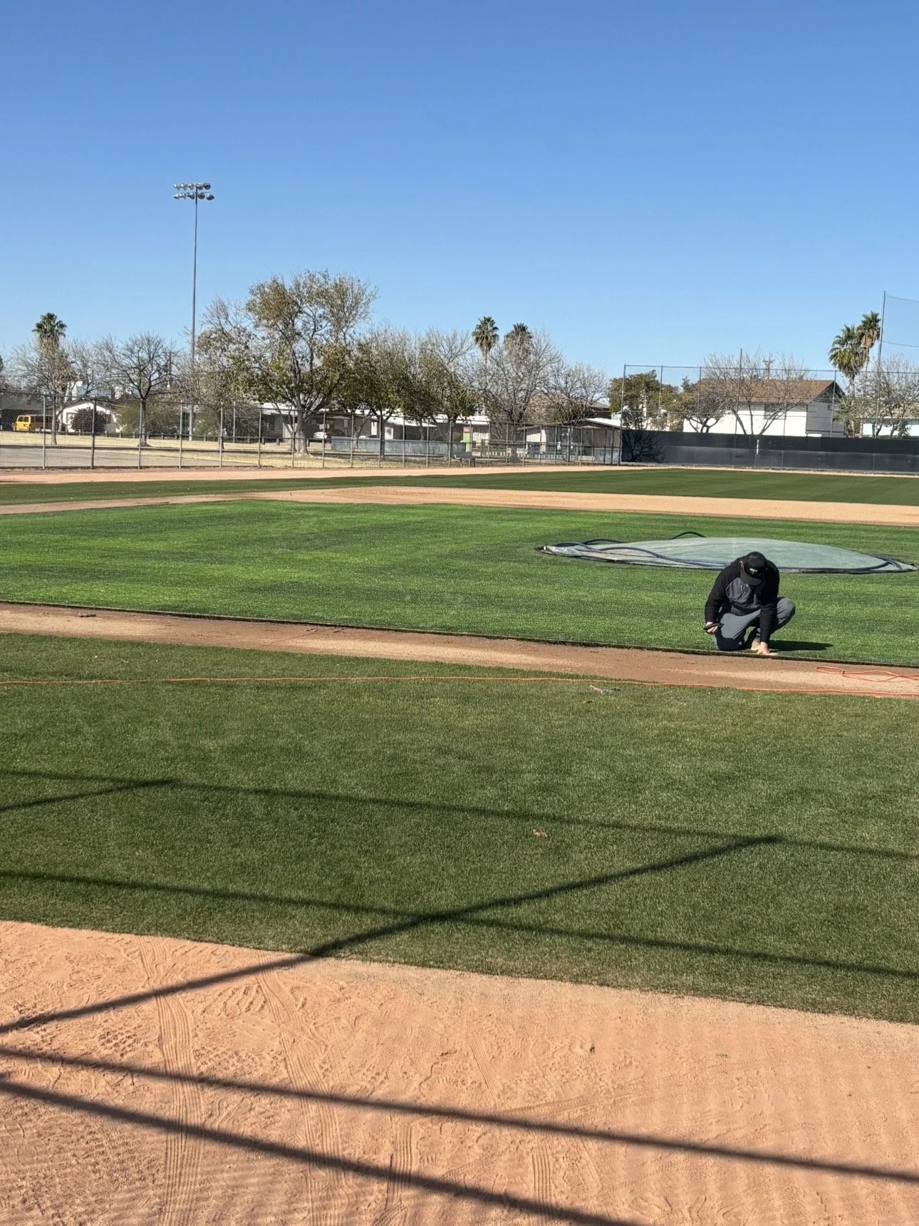 True Hop Field Co, Arizona sports field & court construction, team members working on a baseball field.