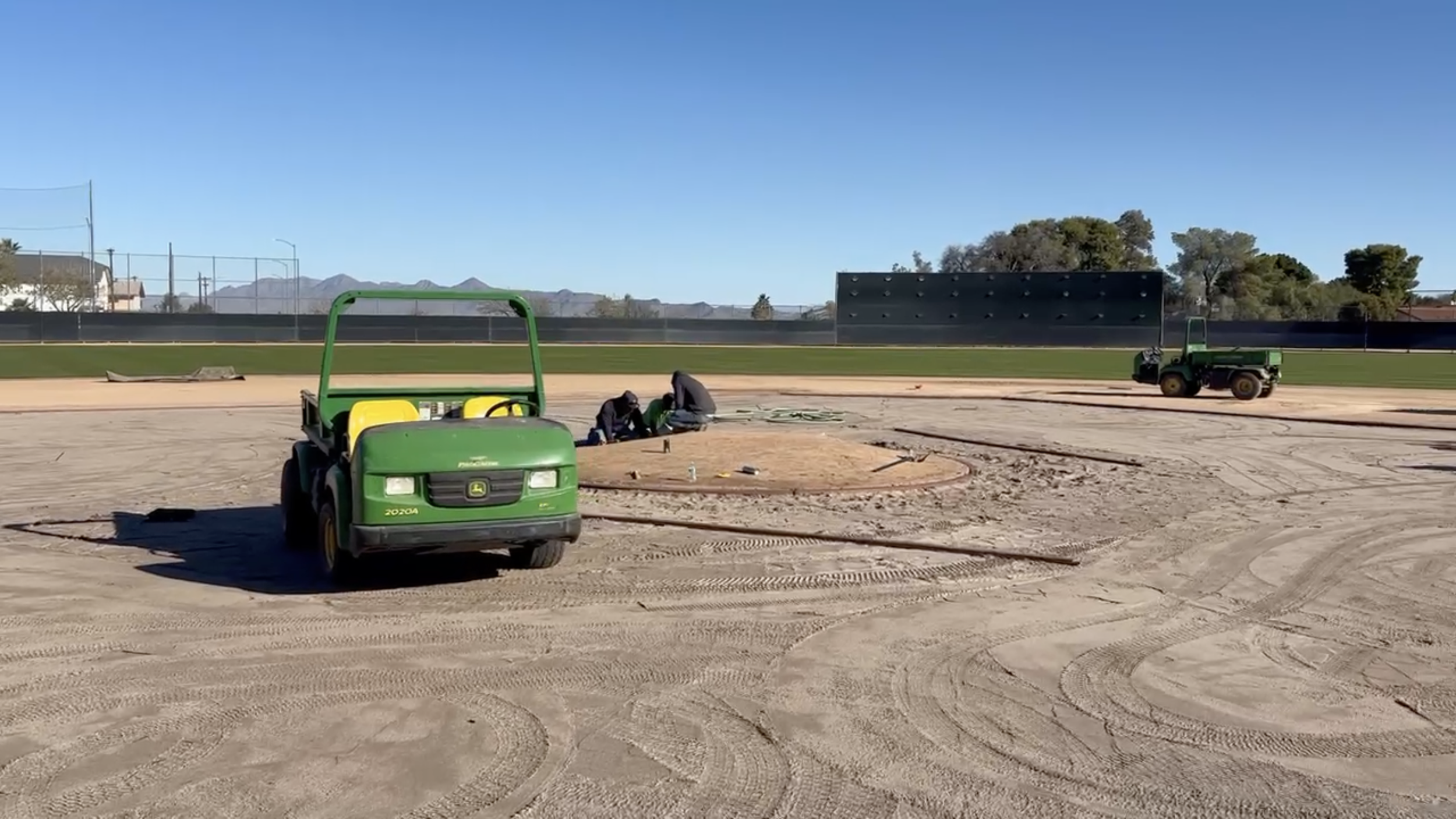 True Hop Field Co team members working on baseball field construction and resurfacing.