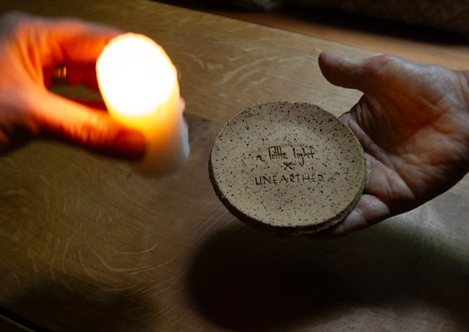 candle being placed on podium dish for internal of wax lantern