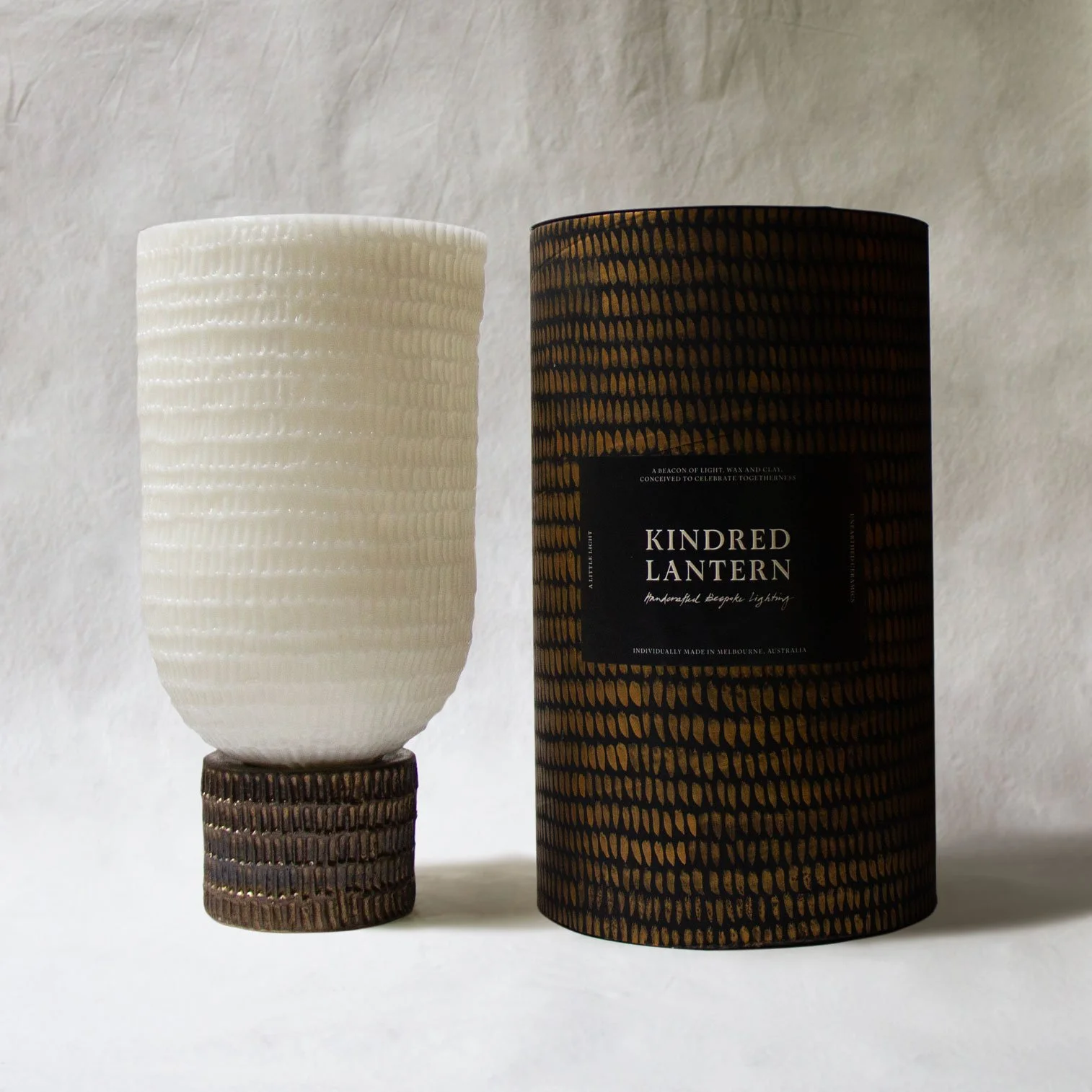 Bespoke Wax lantern with aged bronze glaze on ceramic base and etched pattern on wax shade and handcrafted sustainable packaging