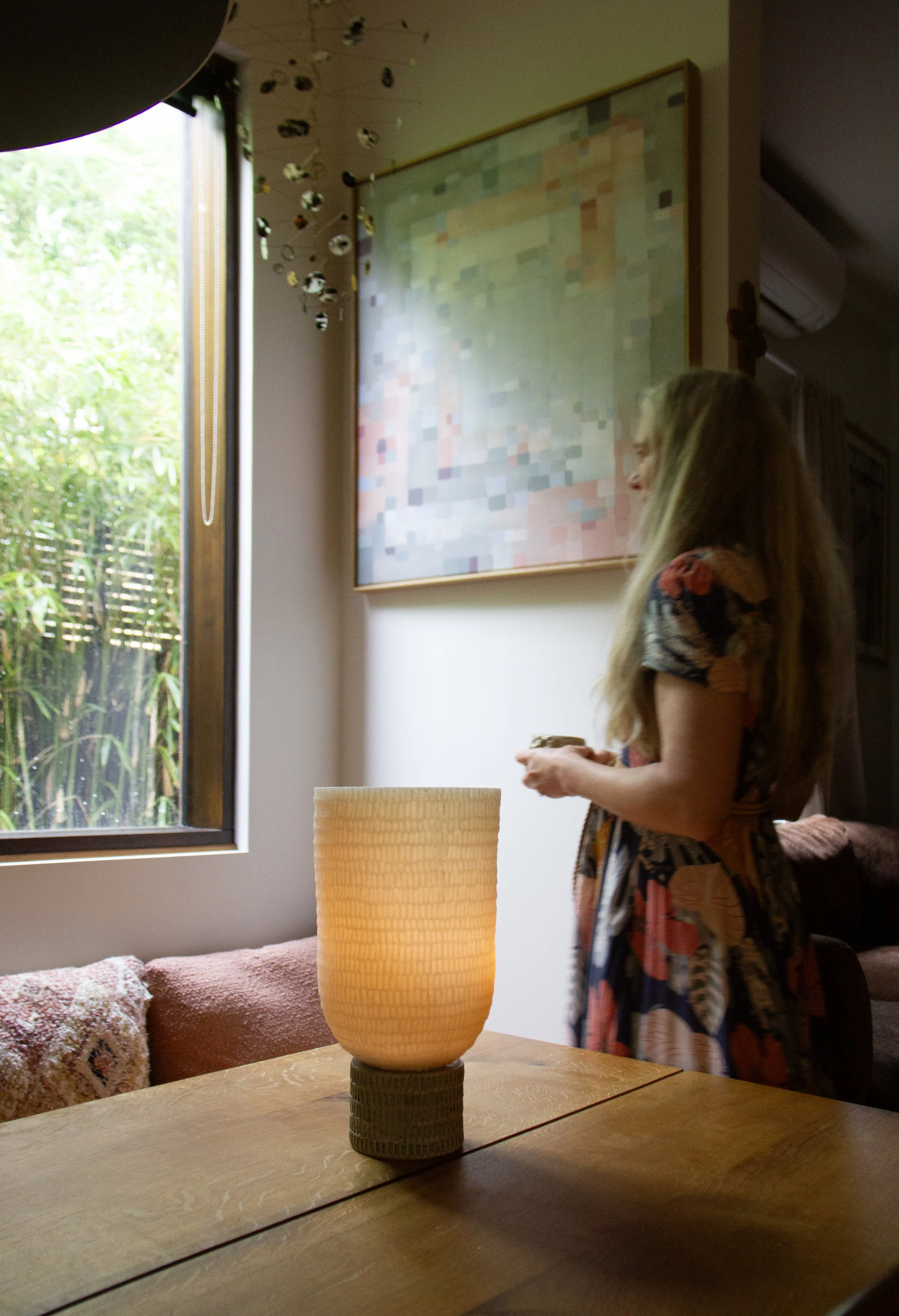 gentle glow of Kindred wax lantern with woman quietly contemplating