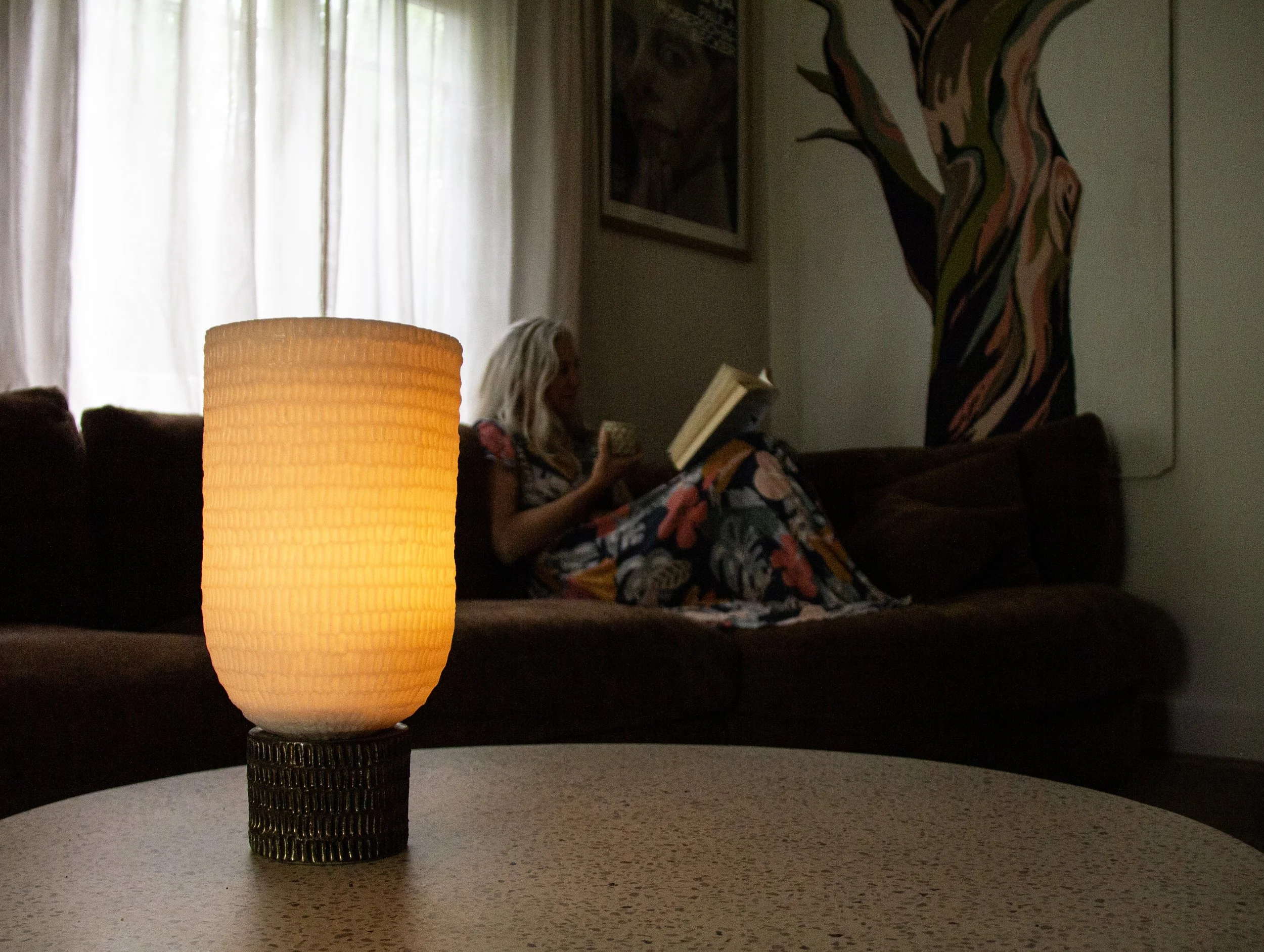 person quietly reading by soft glow of Kindred Wax lantern
