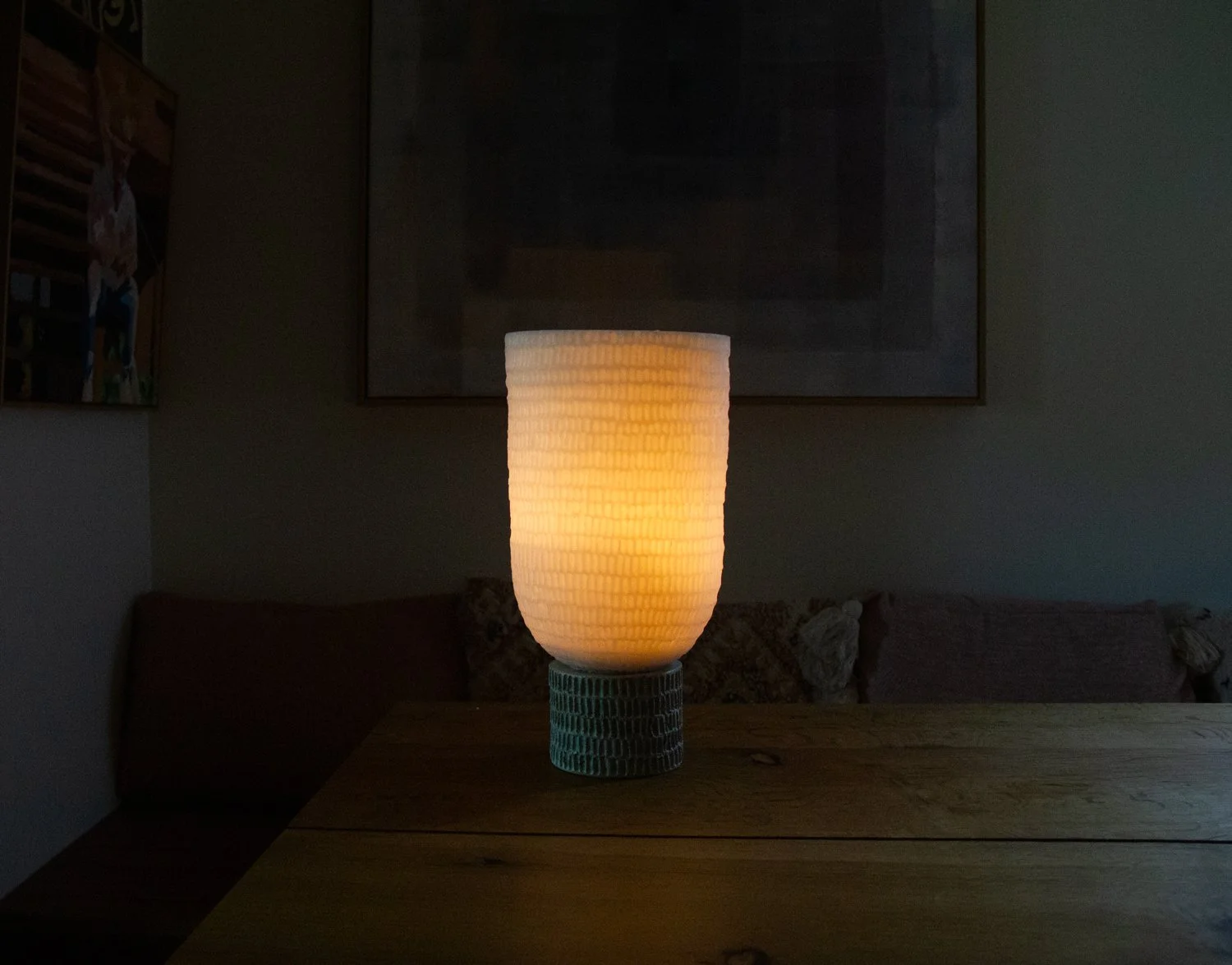 softly glowing Kindred lantern with etched pattern on wax shade