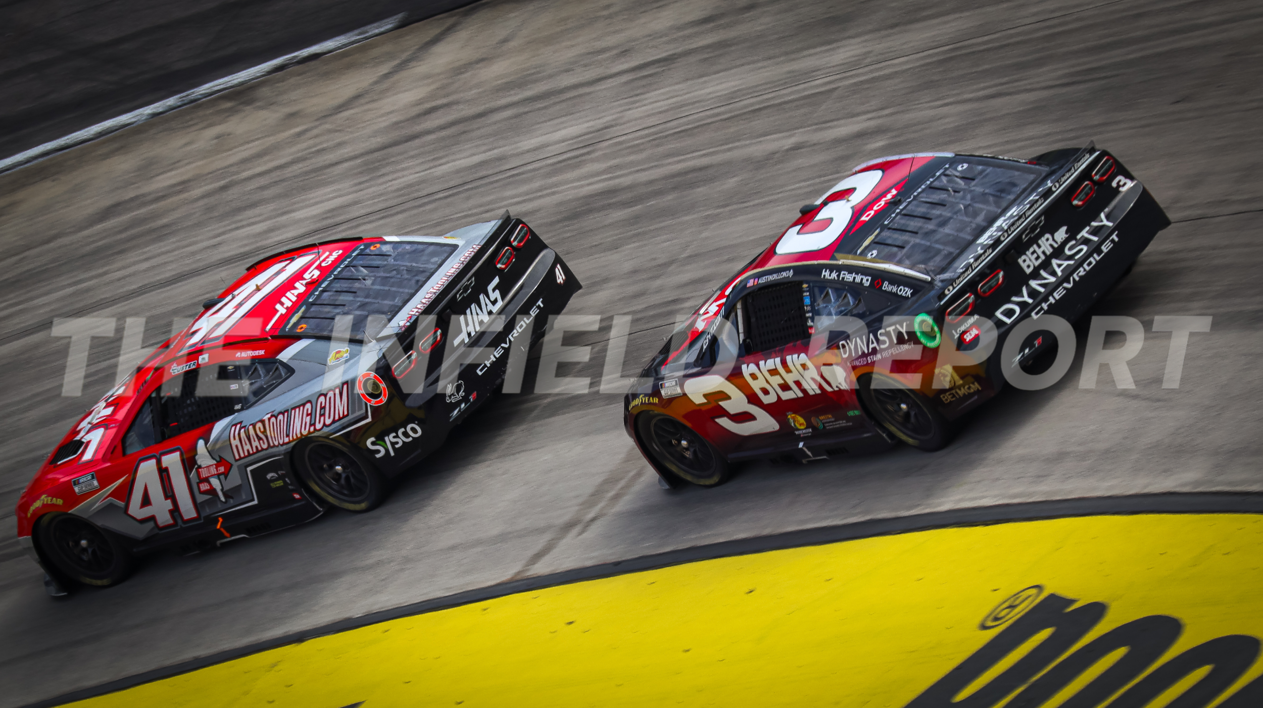 Two race cars on a dirt track, one with the number 41 in red and white, the other with the number 3 in red and black, racing side by side.