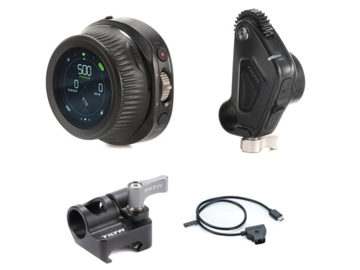 A collection of camera equipment including a digital control wheel, a mounting bracket, a quick-release plate, and a USB cable.