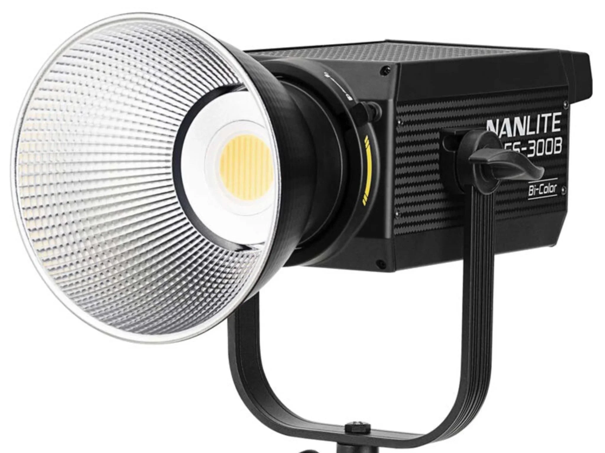 A professional studio strobe light with a large reflector and adjustable focus.