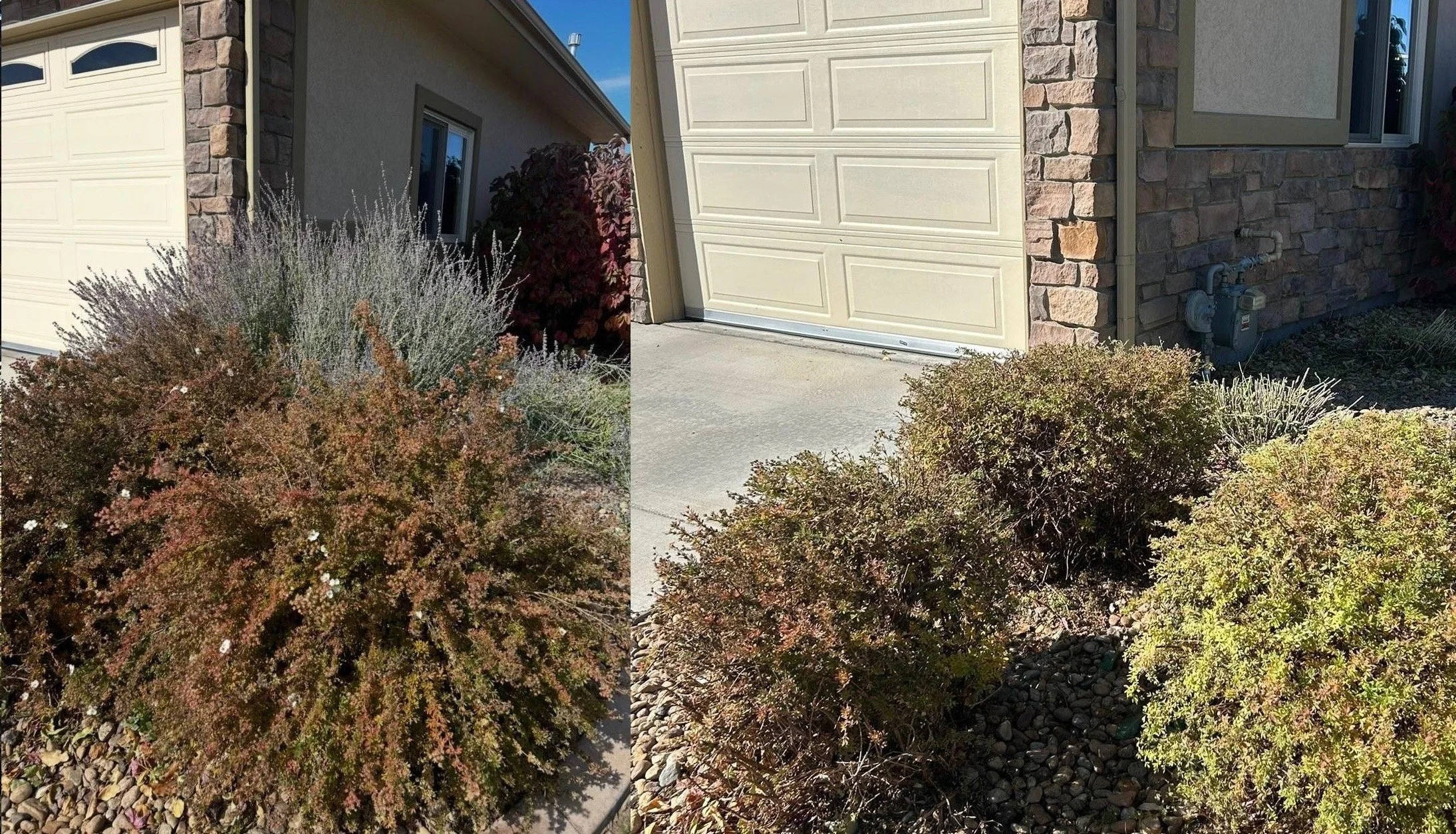 Exterior view of a house showing a flower bed and bushes, with a closed beige garage door and a brick wall in the background.