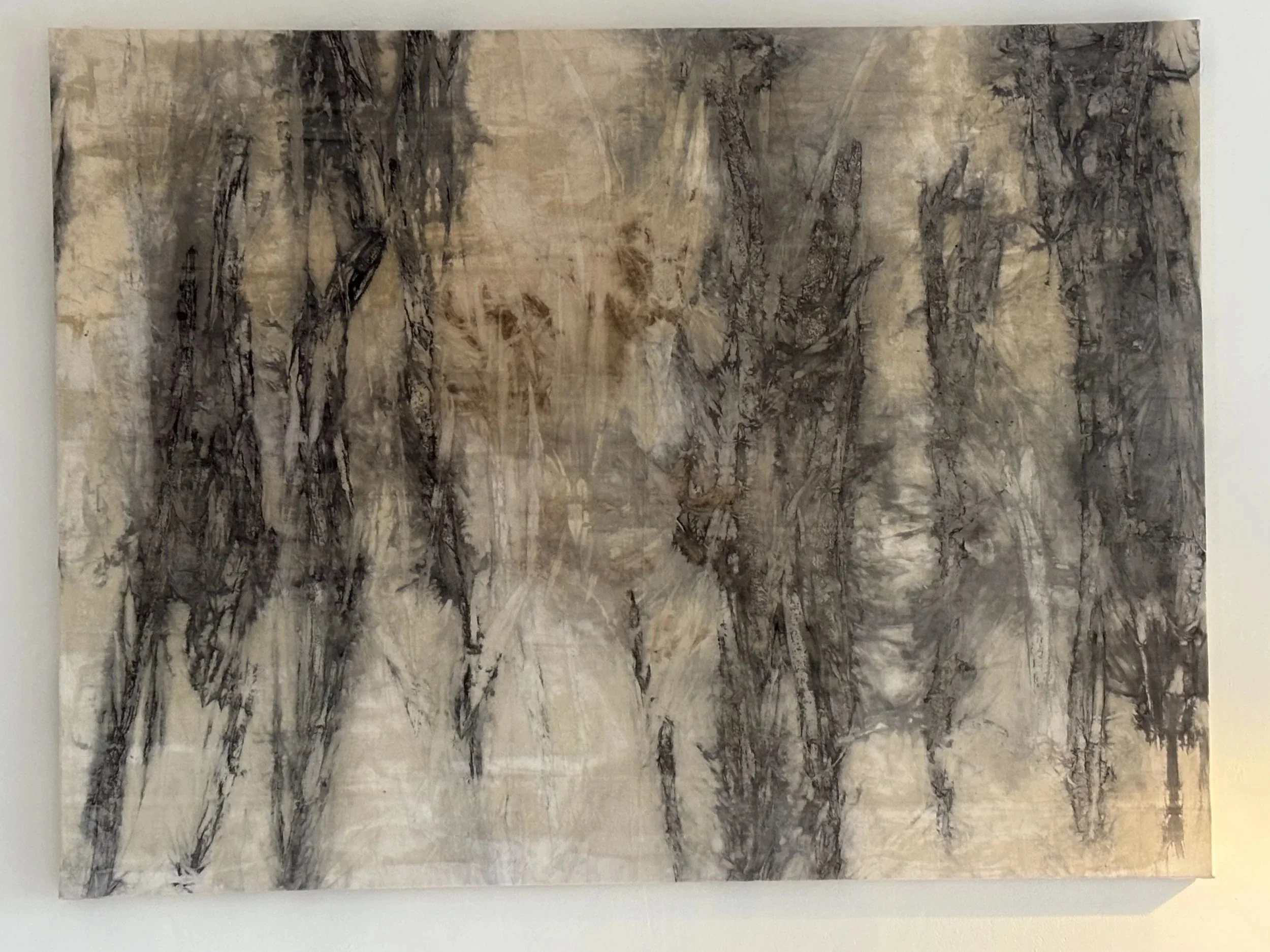 Abstract black and brown ink brush painting on light beige paper, depicting a forest scene with trees and branches.