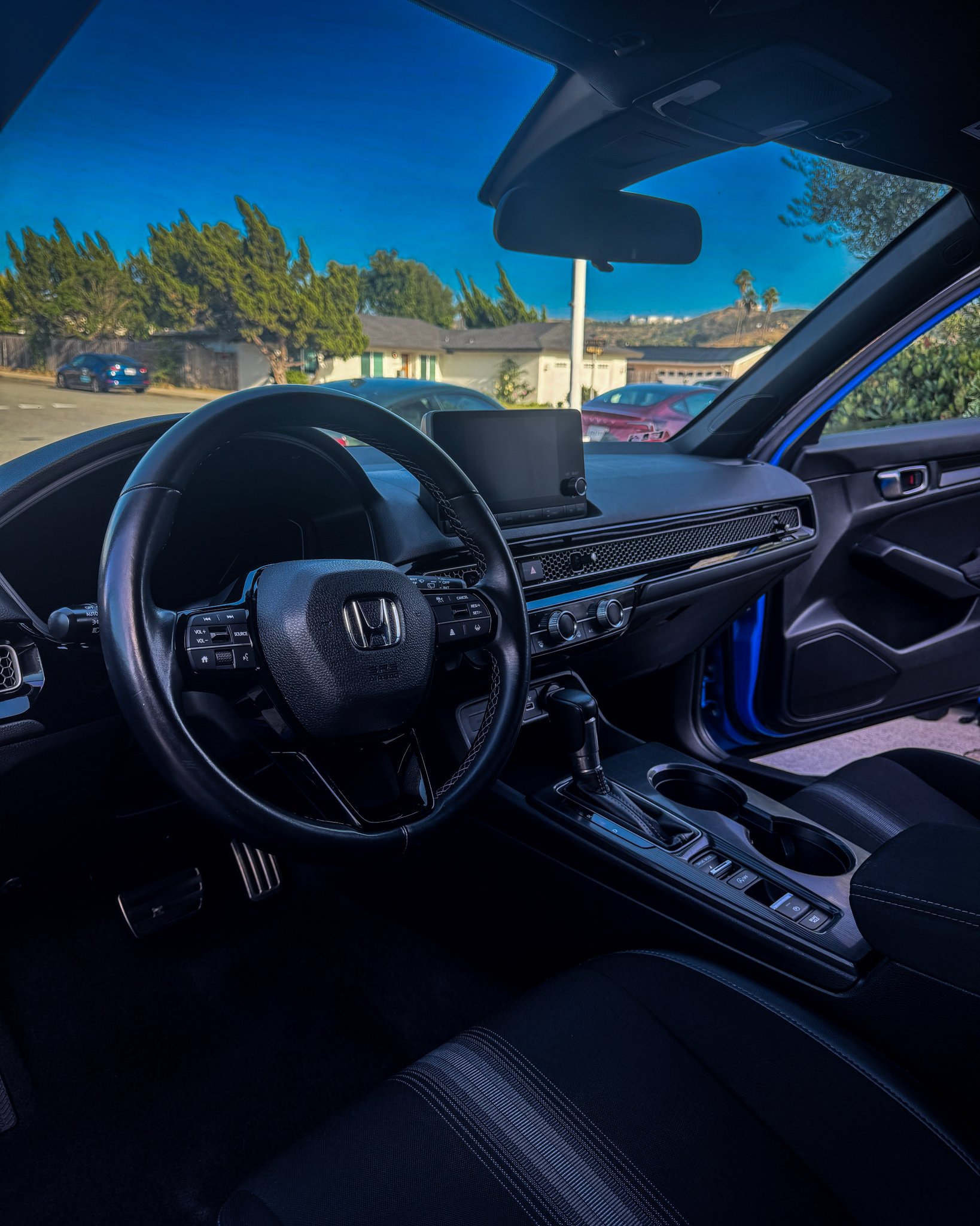 Detailed Honda Civic Sport Interior showing clean dashboard, steering wheel, and center console after a Santo's Suds interior detail