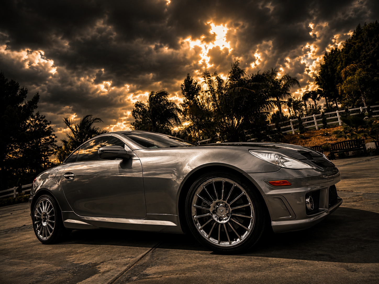 Detailed Mercedes SLK with mirror-like paint reflections at golden hour showcasing Santo's Suds premium detailing results