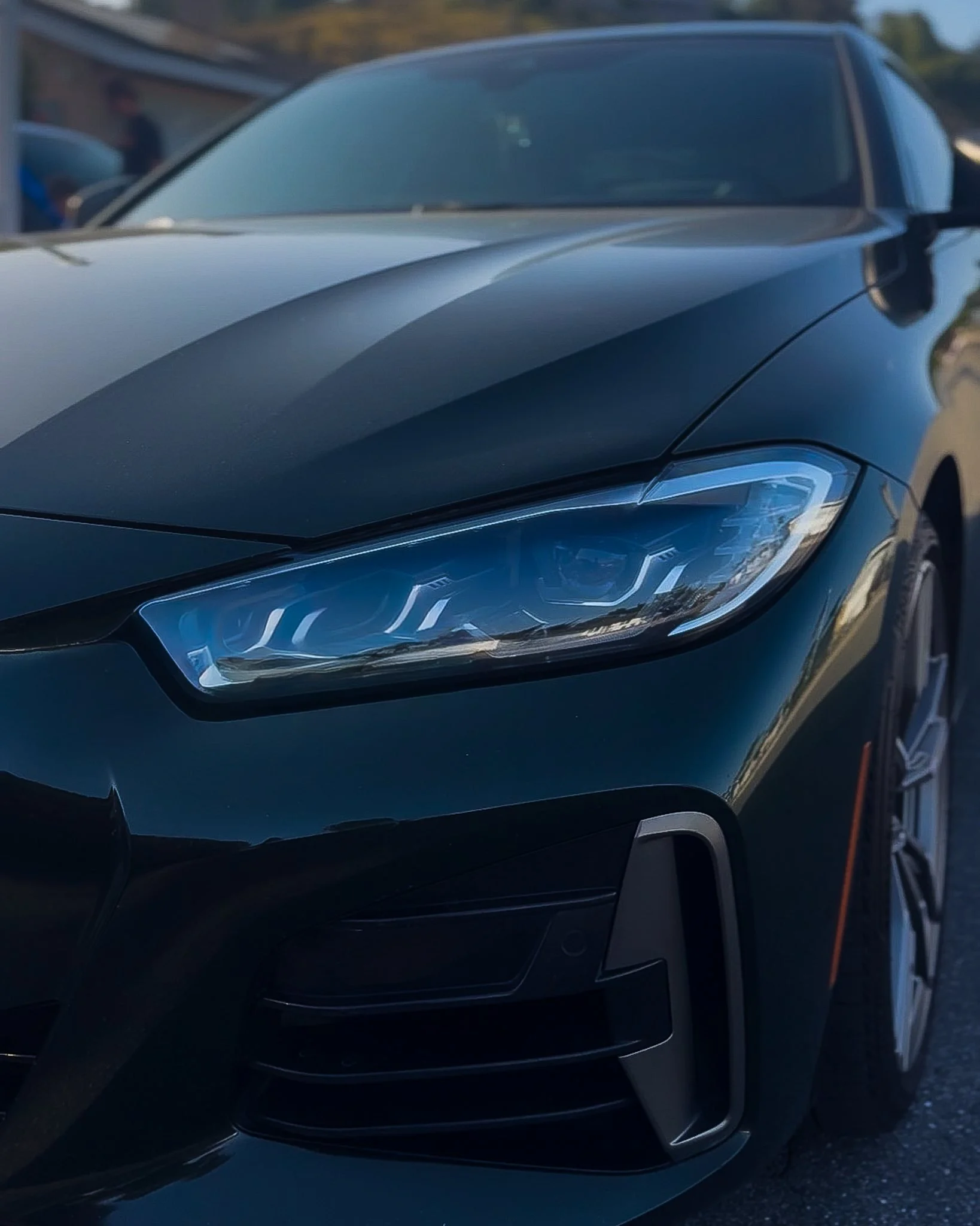 Close-up of glossy BMW paint and headlight after a premium detail
