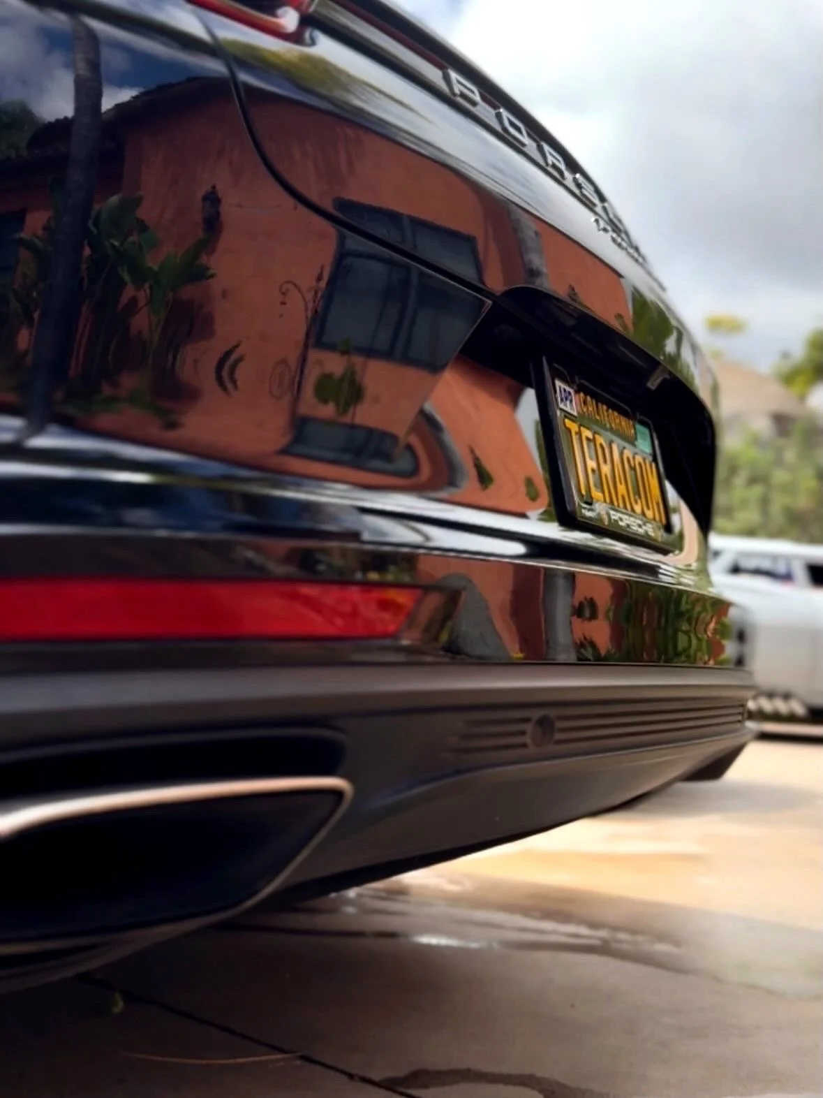 Mirror-like reflections in black Porsche paint after an exterior detail