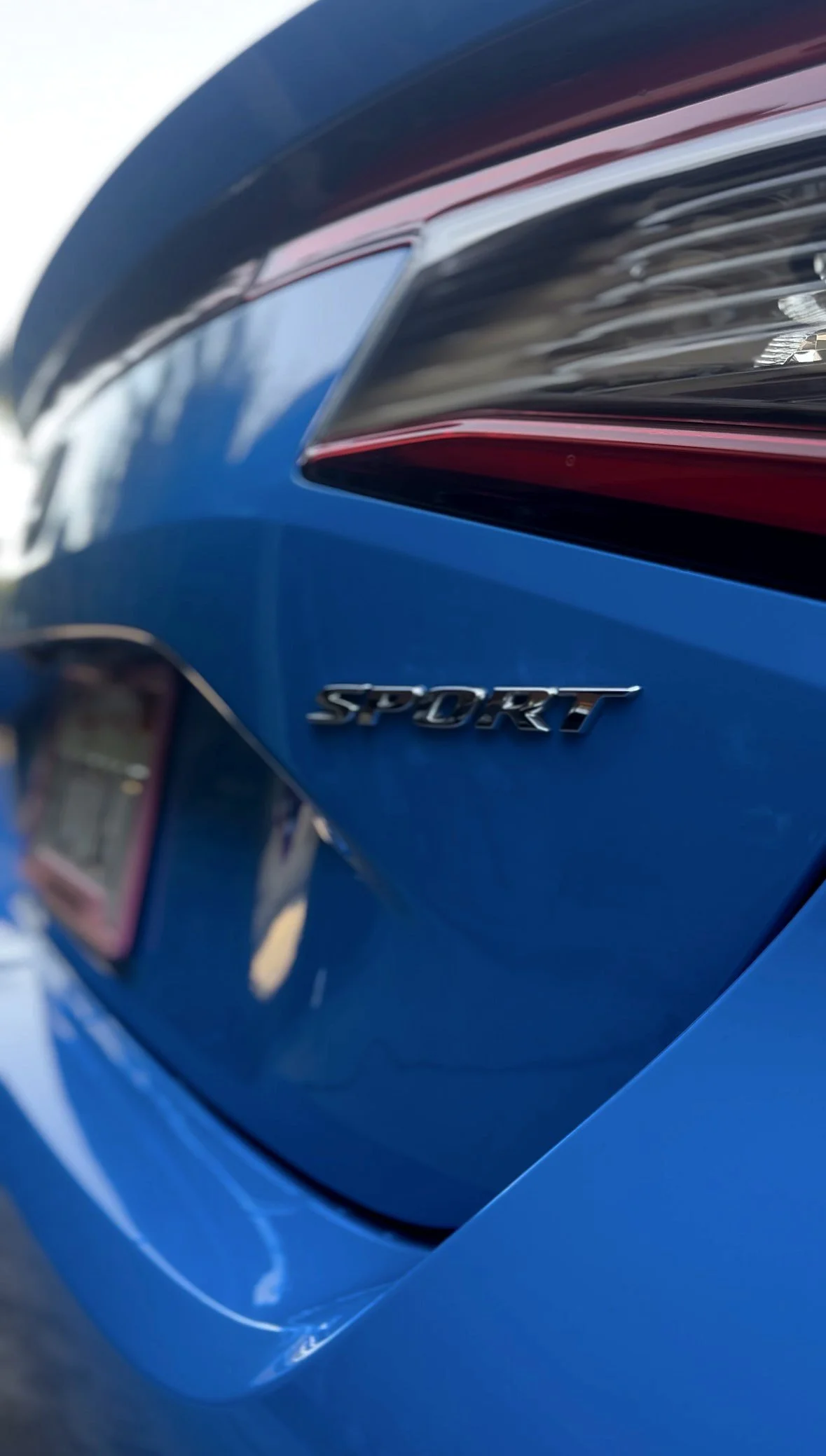 Blue Honda Civic Sport badge and glossy rear paint after an exterior detail