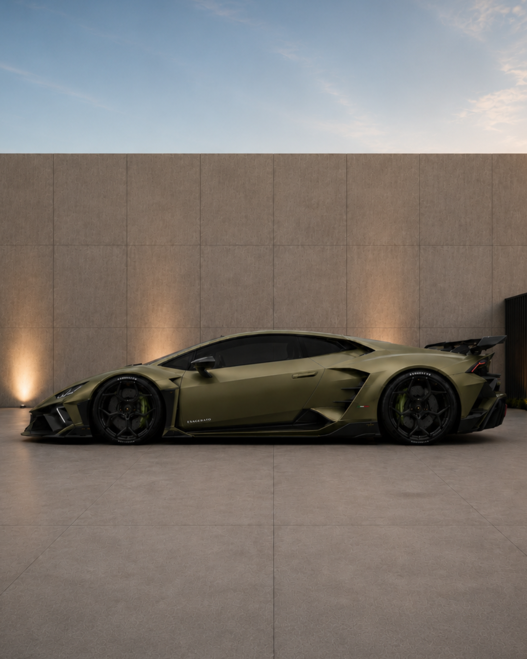 A matte olive green Esagerato Lamborghini Huracan parked outdoors against a beige wall with subtle lighting, with a clear sky in the background.