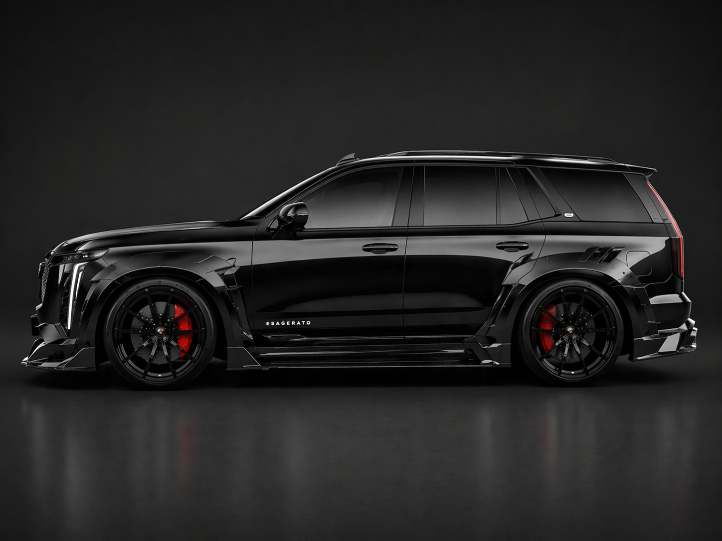 A sleek black luxury SUV with a matte finish, red brake calipers, black alloy wheels, and aerodynamic enhancements, set against a dark background.