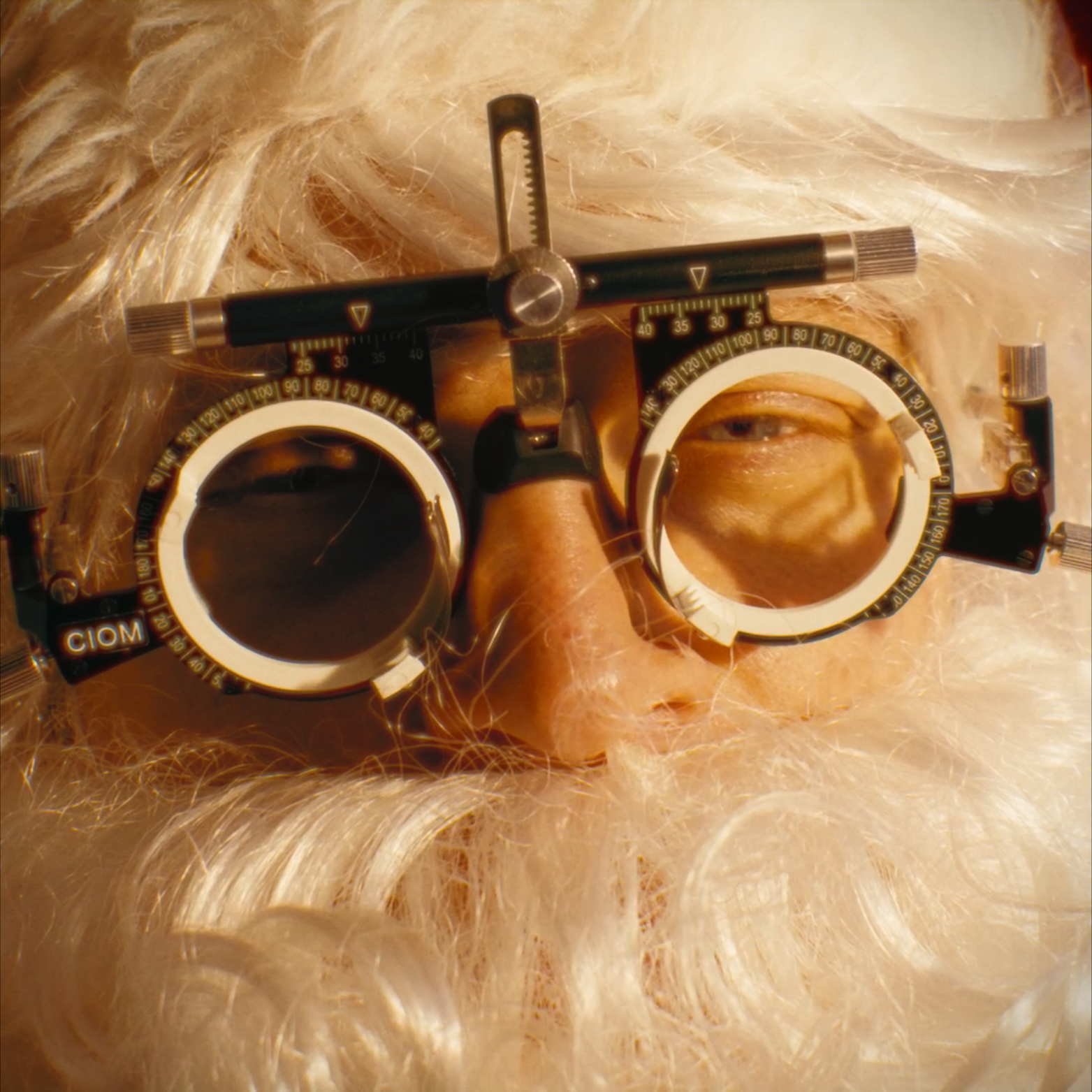 Close-up of an ophthalmologist's trial frame with lenses on a patient's face to test eyeglasses.