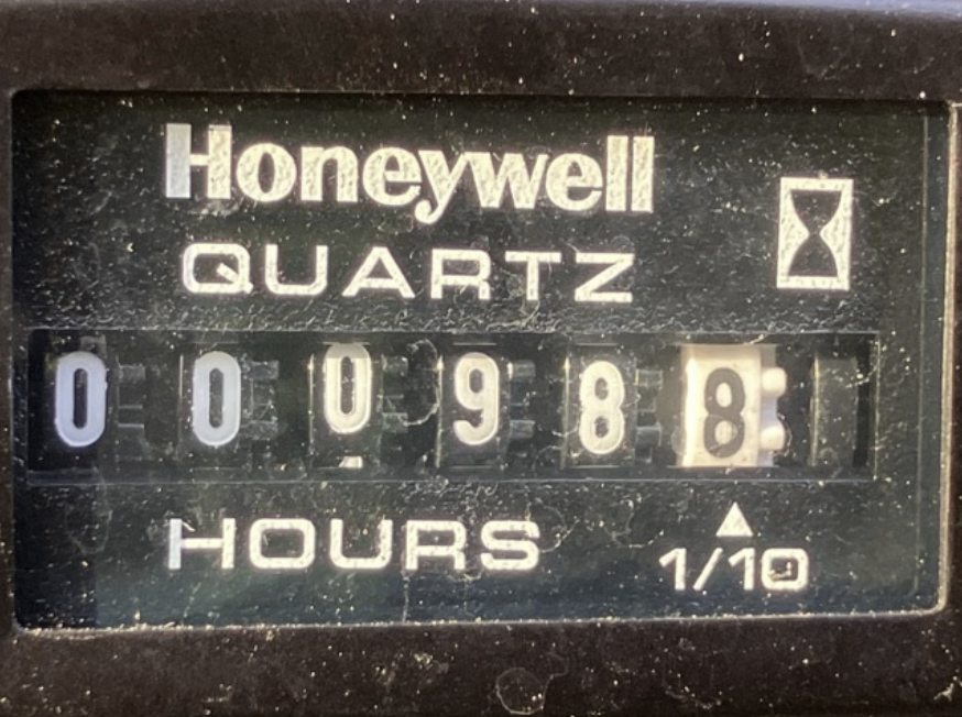 A Honeywell Quartz time clock showing 9:09, with a label indicating 0.0 hours.
