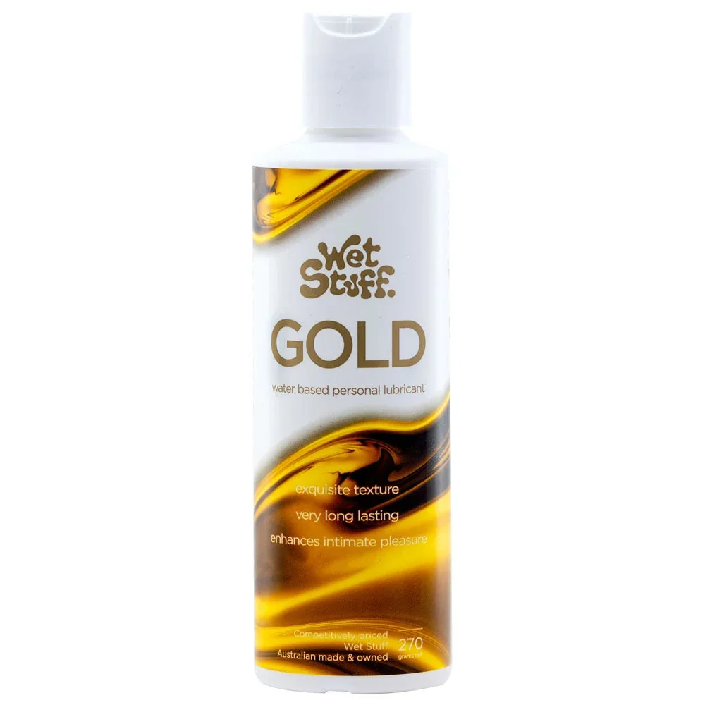 A white bottle labeled 'Wet Stuff Gold', a water-based personal lubricant with a gold and black swirl design on the label.